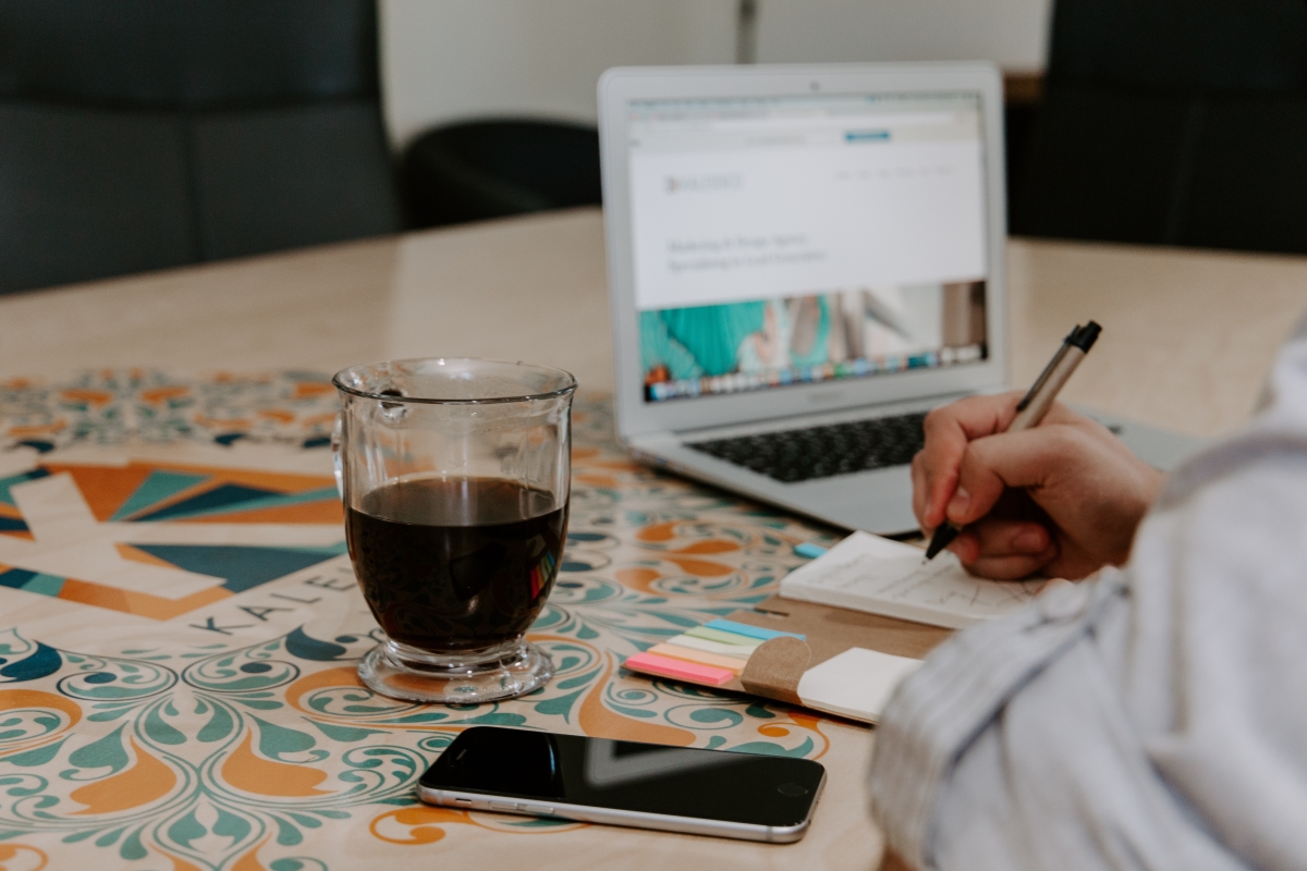 Person Working on Planning Their Mobile App By Taking Notes