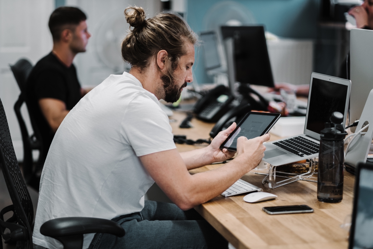 Male Software Developer Working on Project on His Tablet