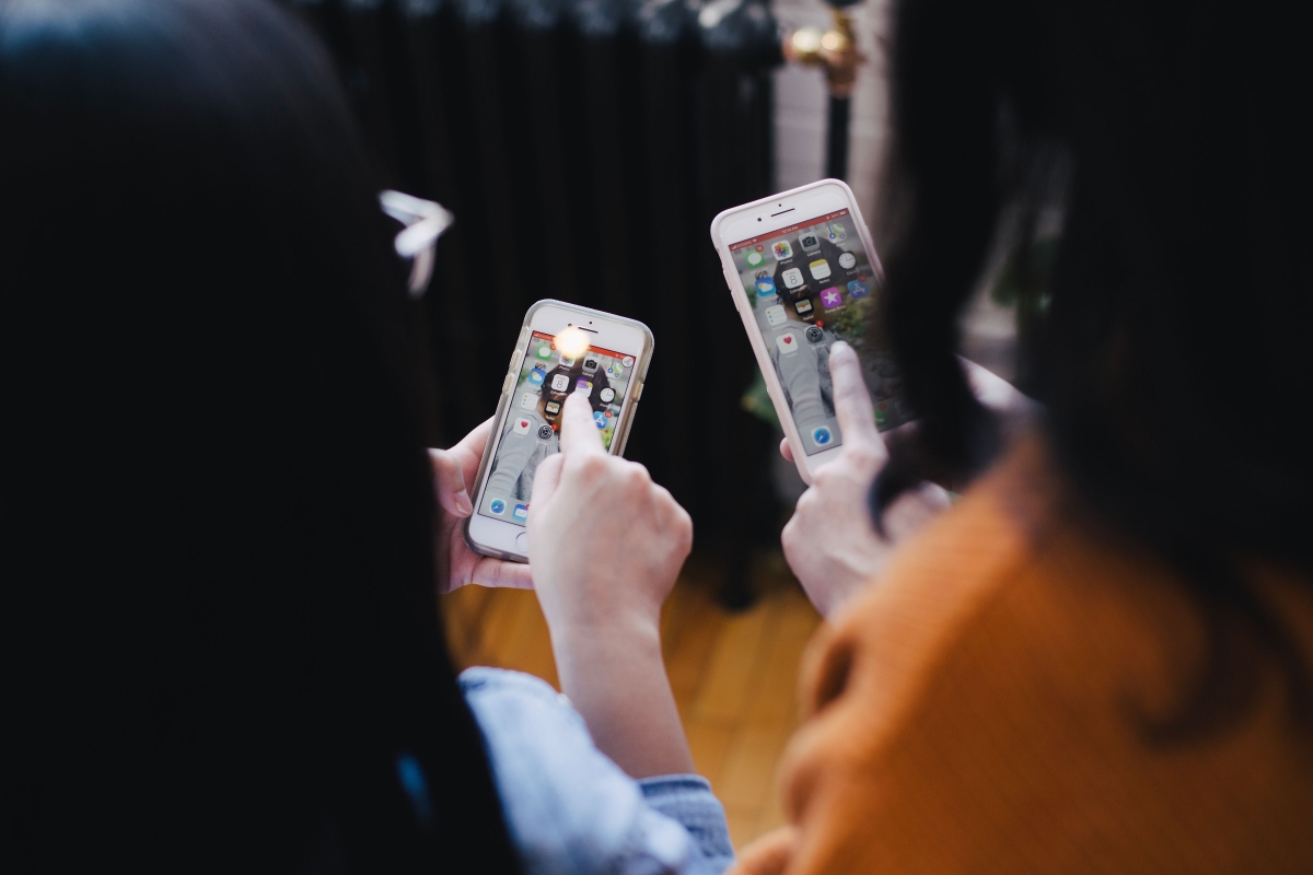 Two Women Testing Mobile Apps on Their Smartphones