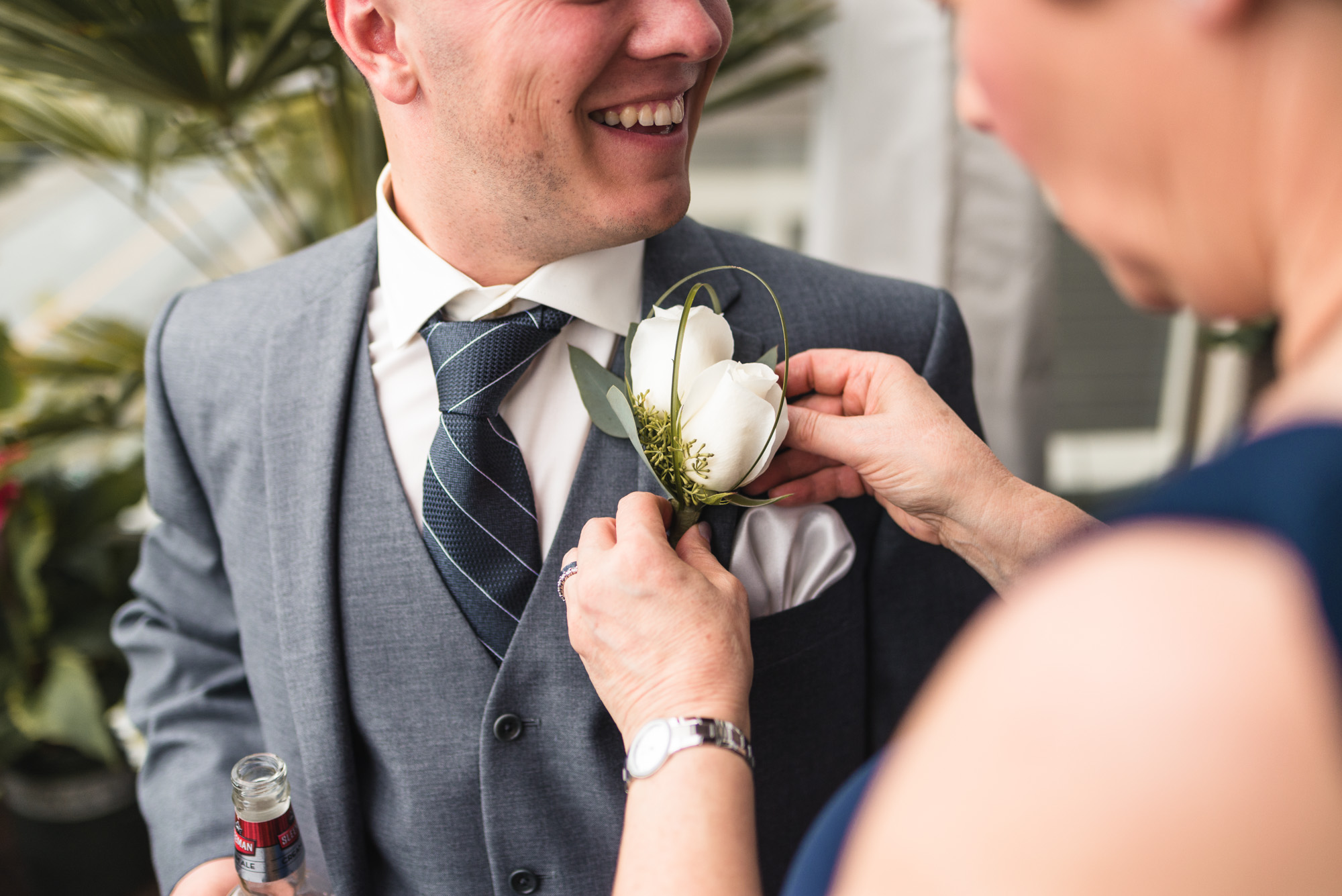 Pinning the boutineer on the Groom