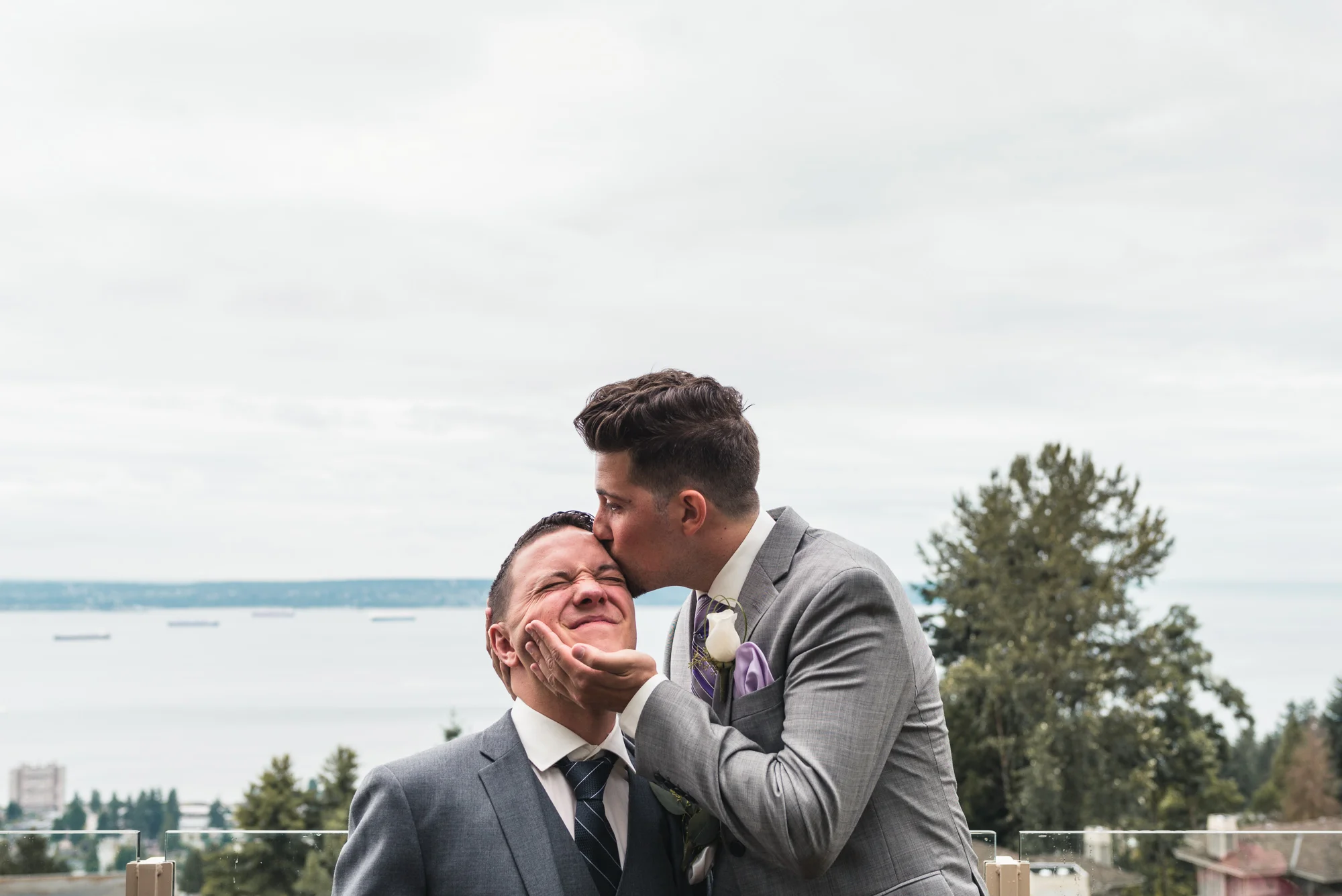 Groomsman kissing the Groom