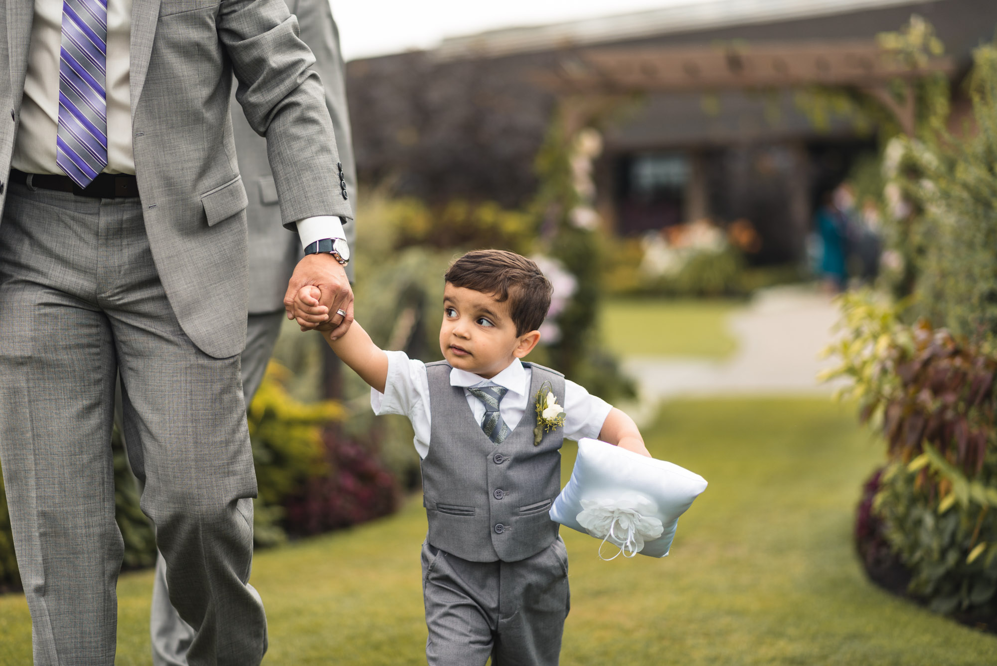 Ring bearer walking with dad