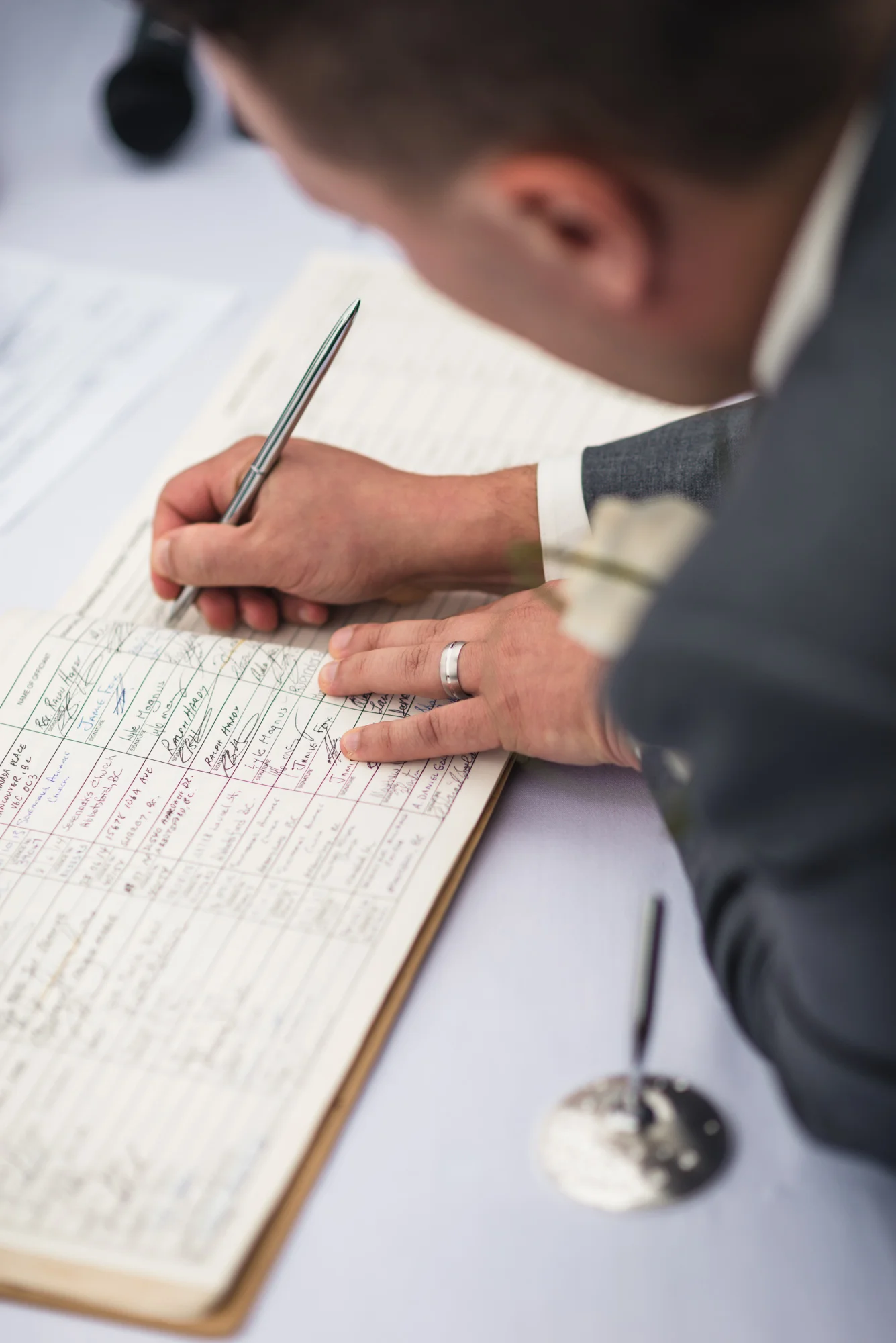 Groom signing marriage lisence