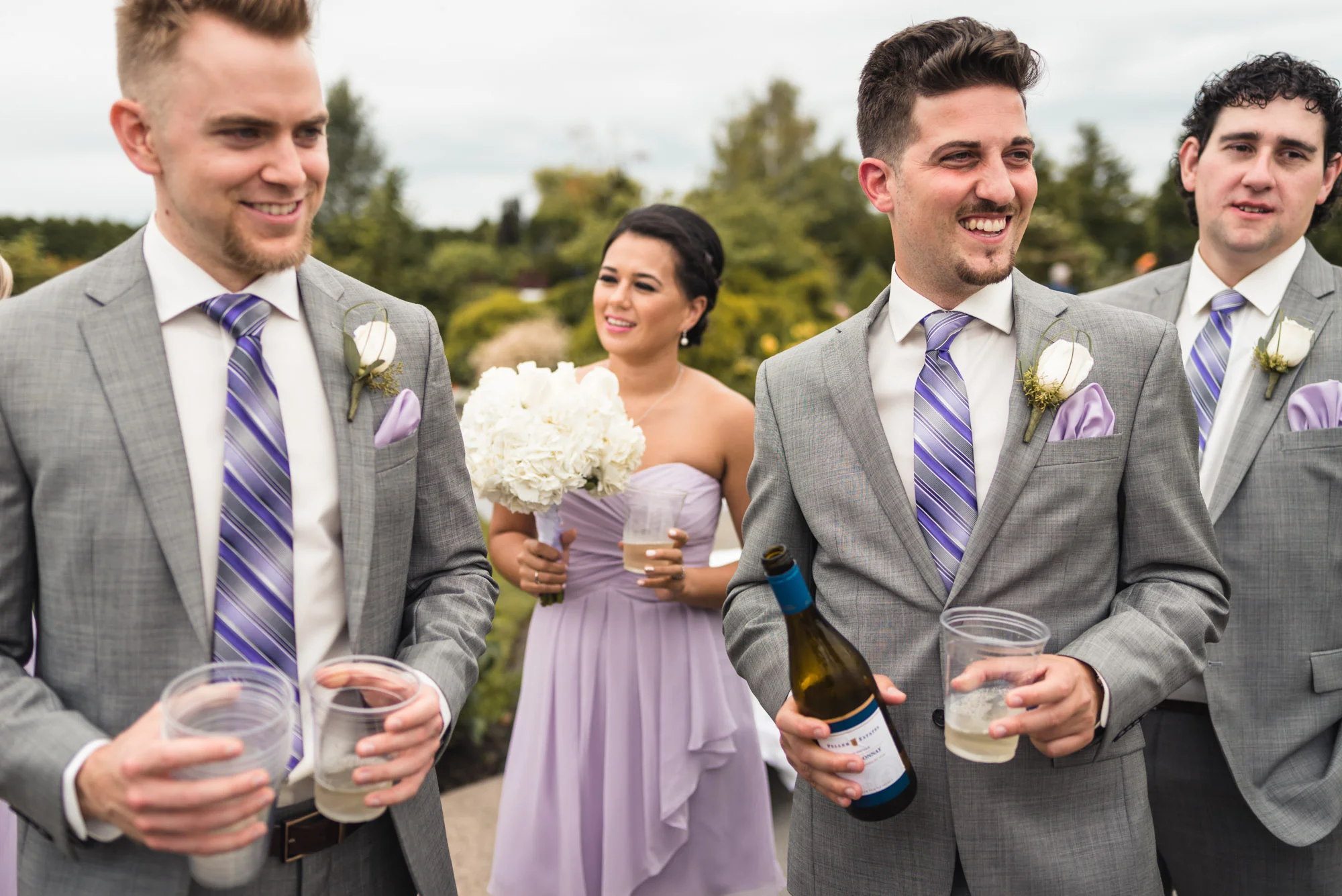 Groomsmen with wine bottle