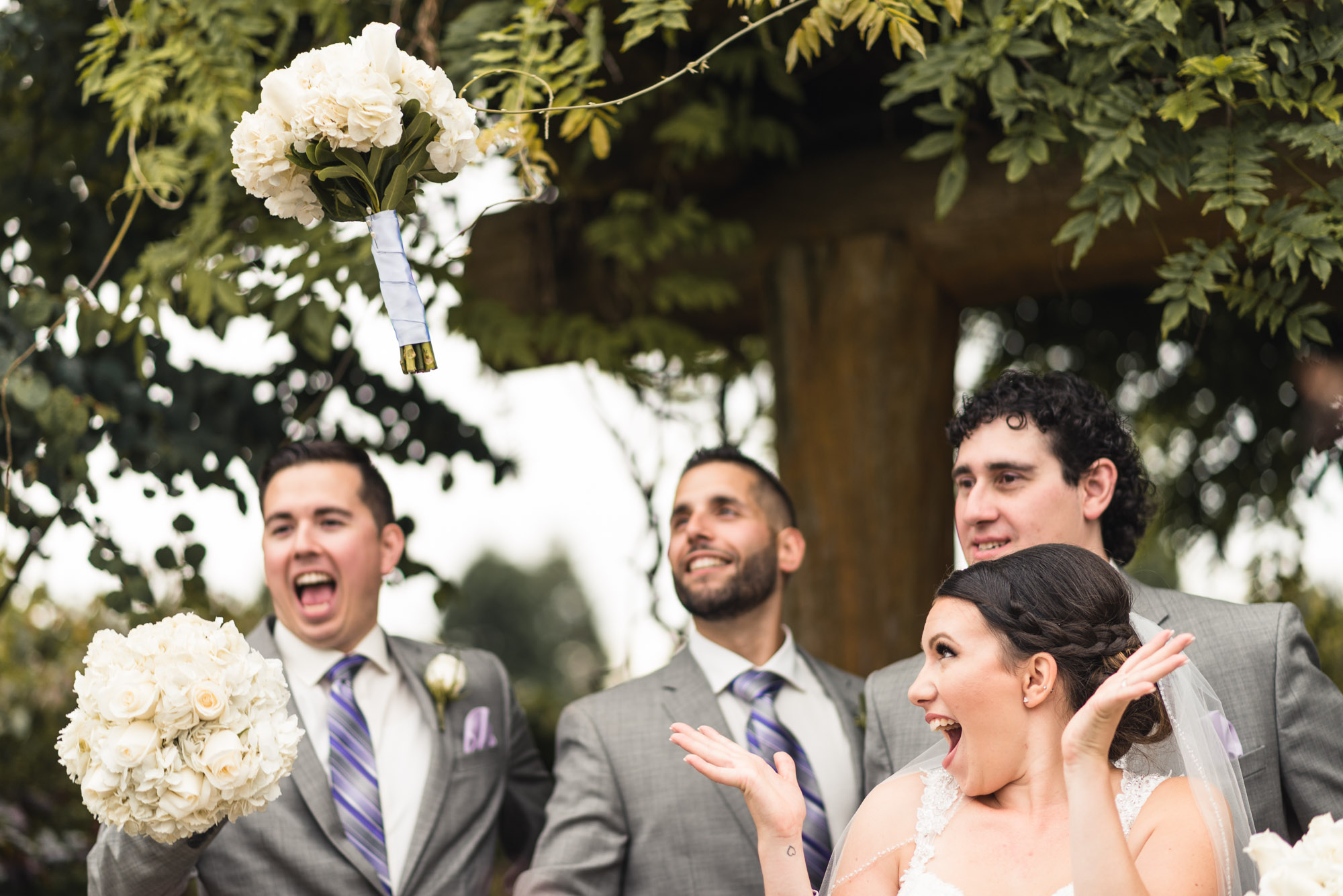 Groomsmen and Bride tossing bouquets
