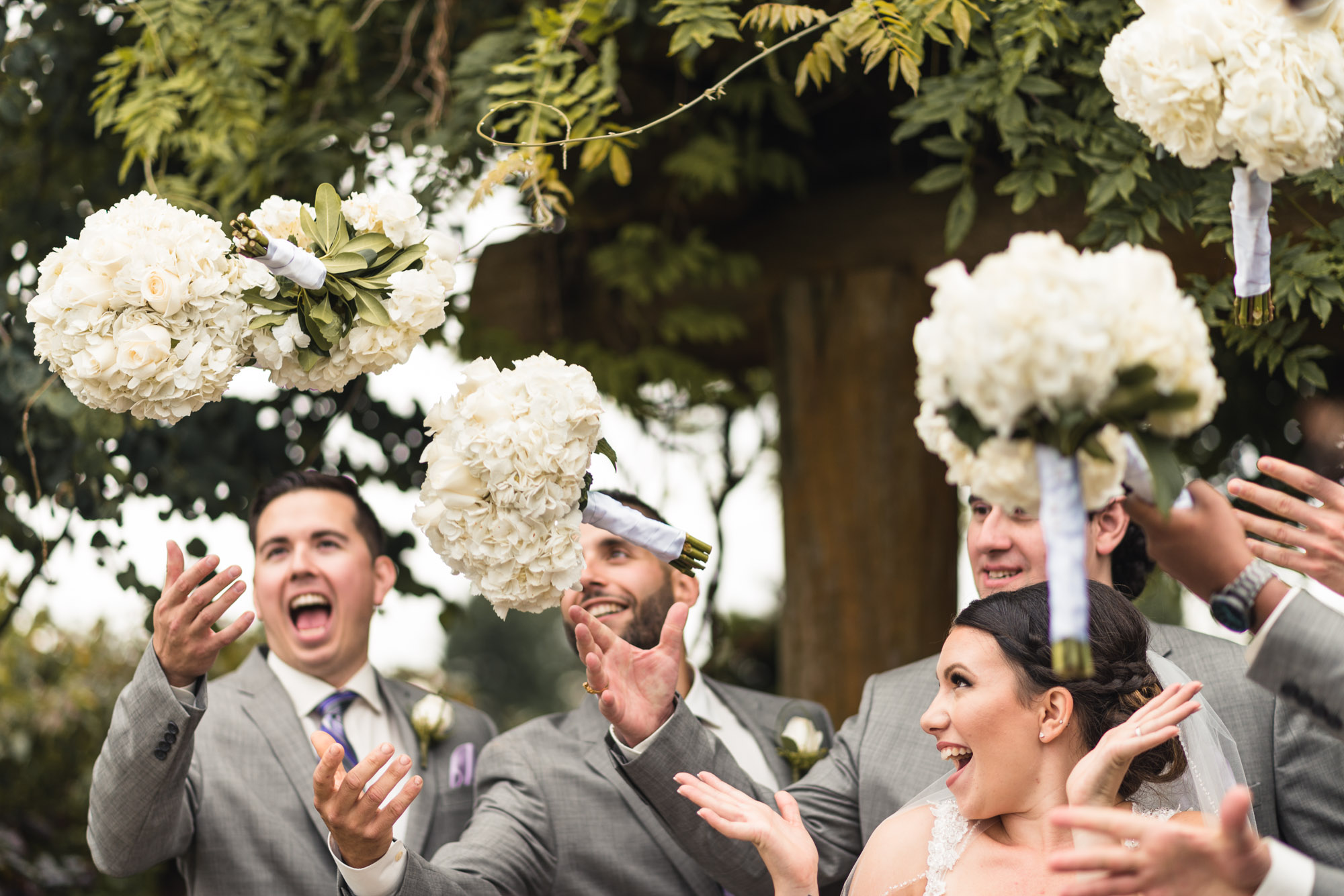 Groomsmen and Bride tossing bouquets