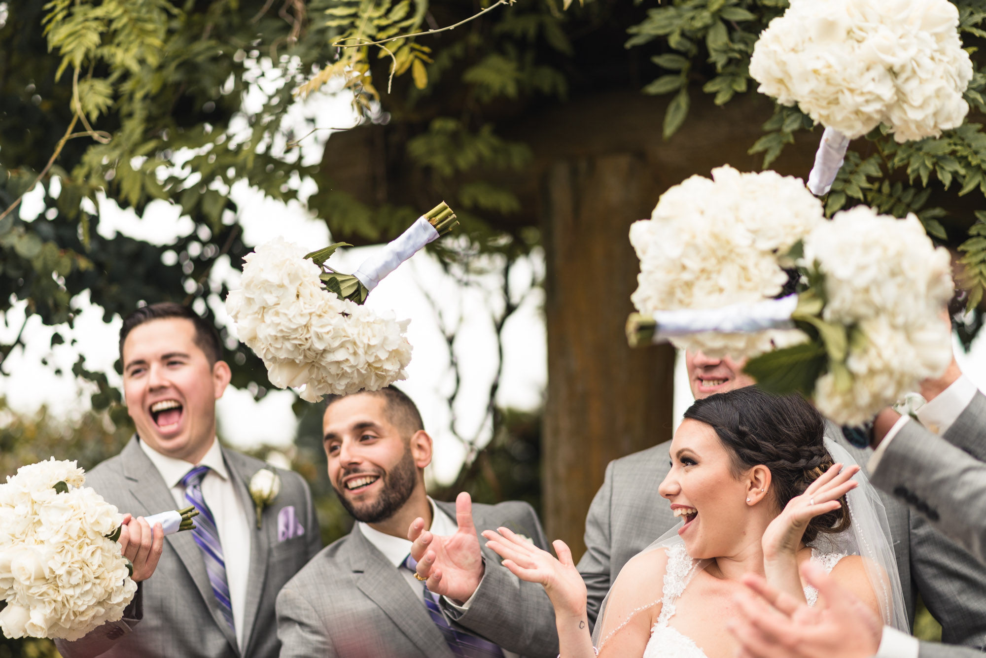 Groomsmen and Bride tossing bouquets