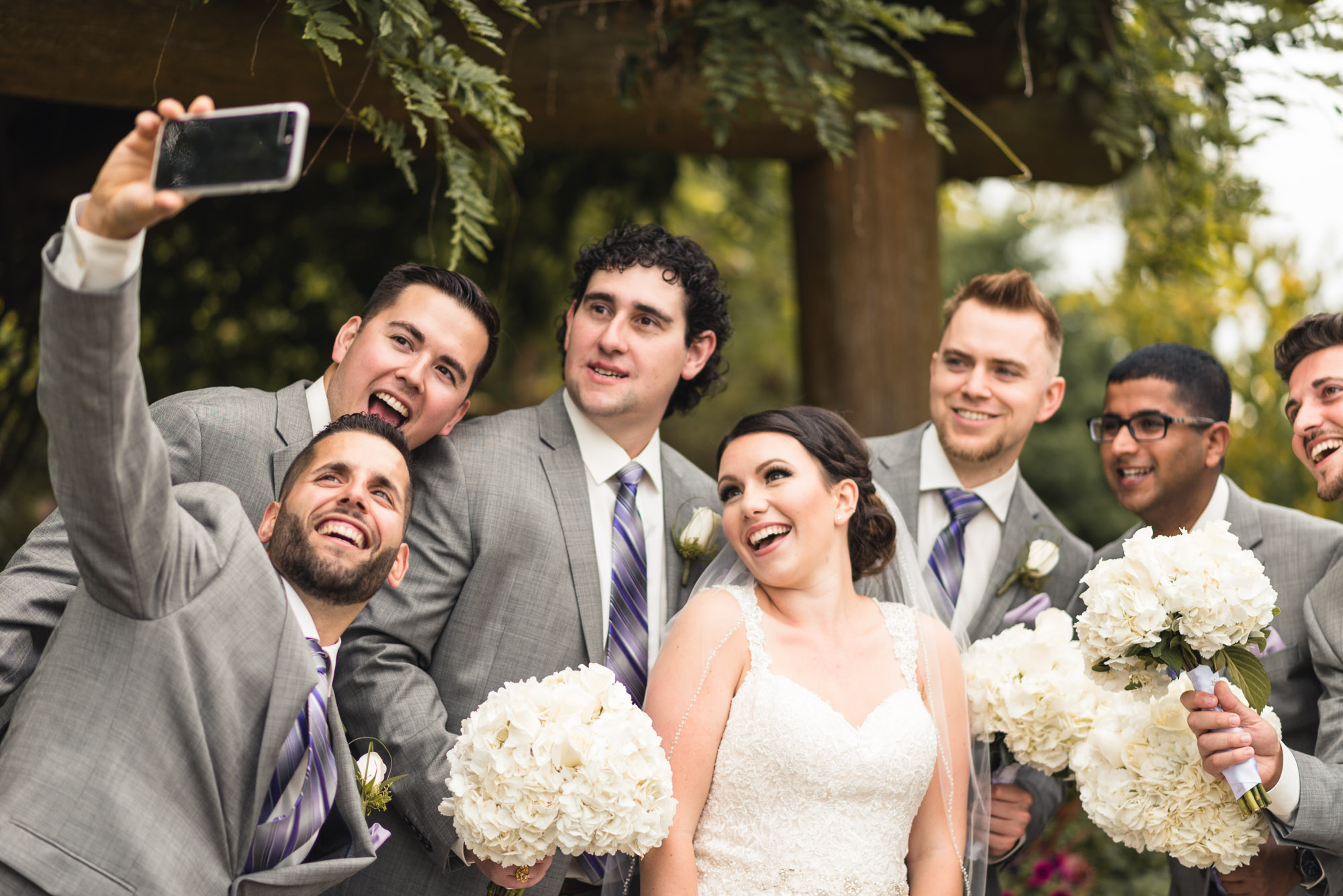 Groomsmen taking selfie with Bride