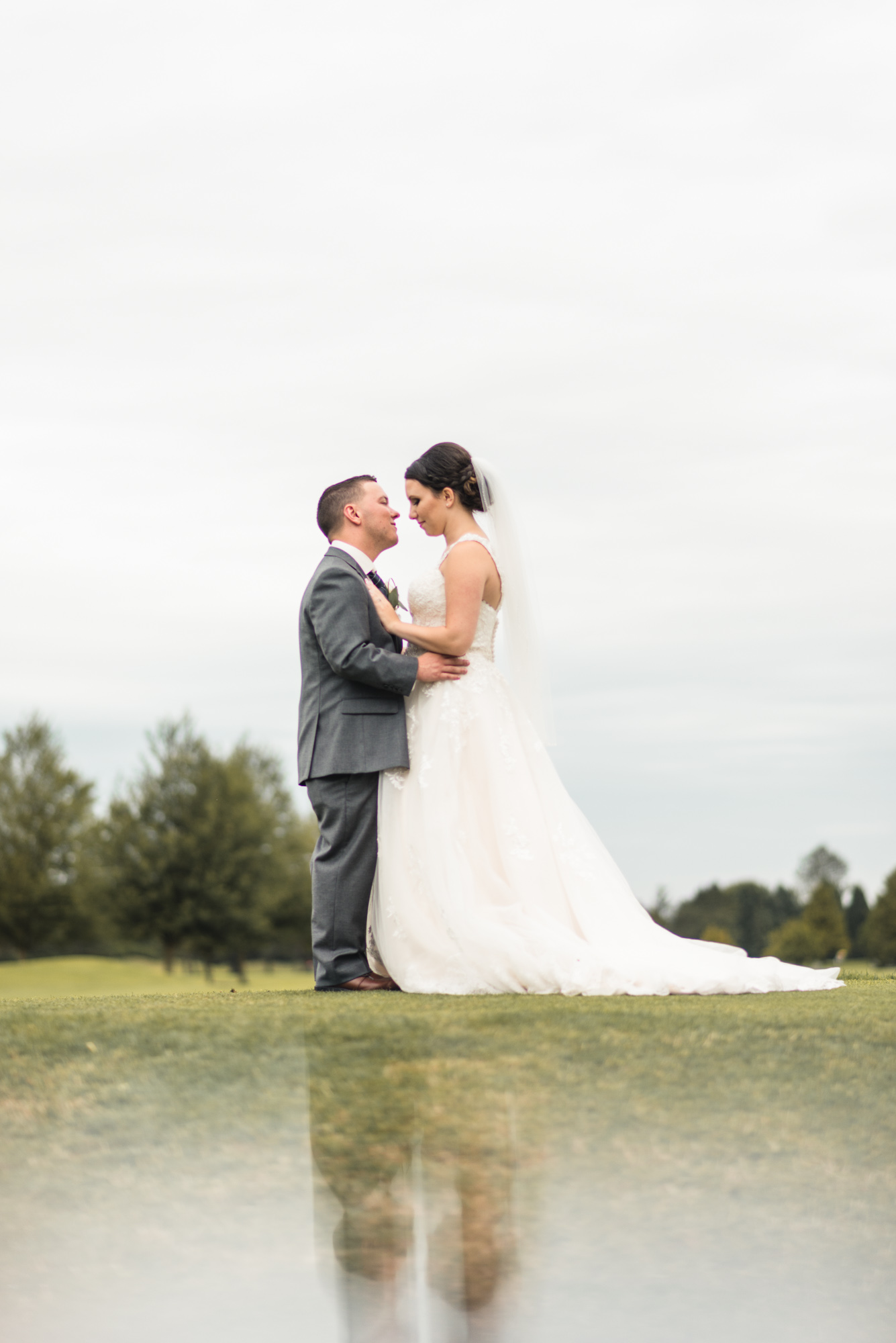 Bride and Groom kissing with reflection