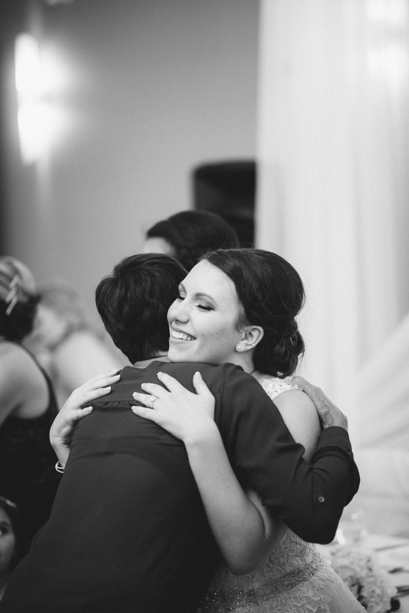 Bride hugs guest at receiving line