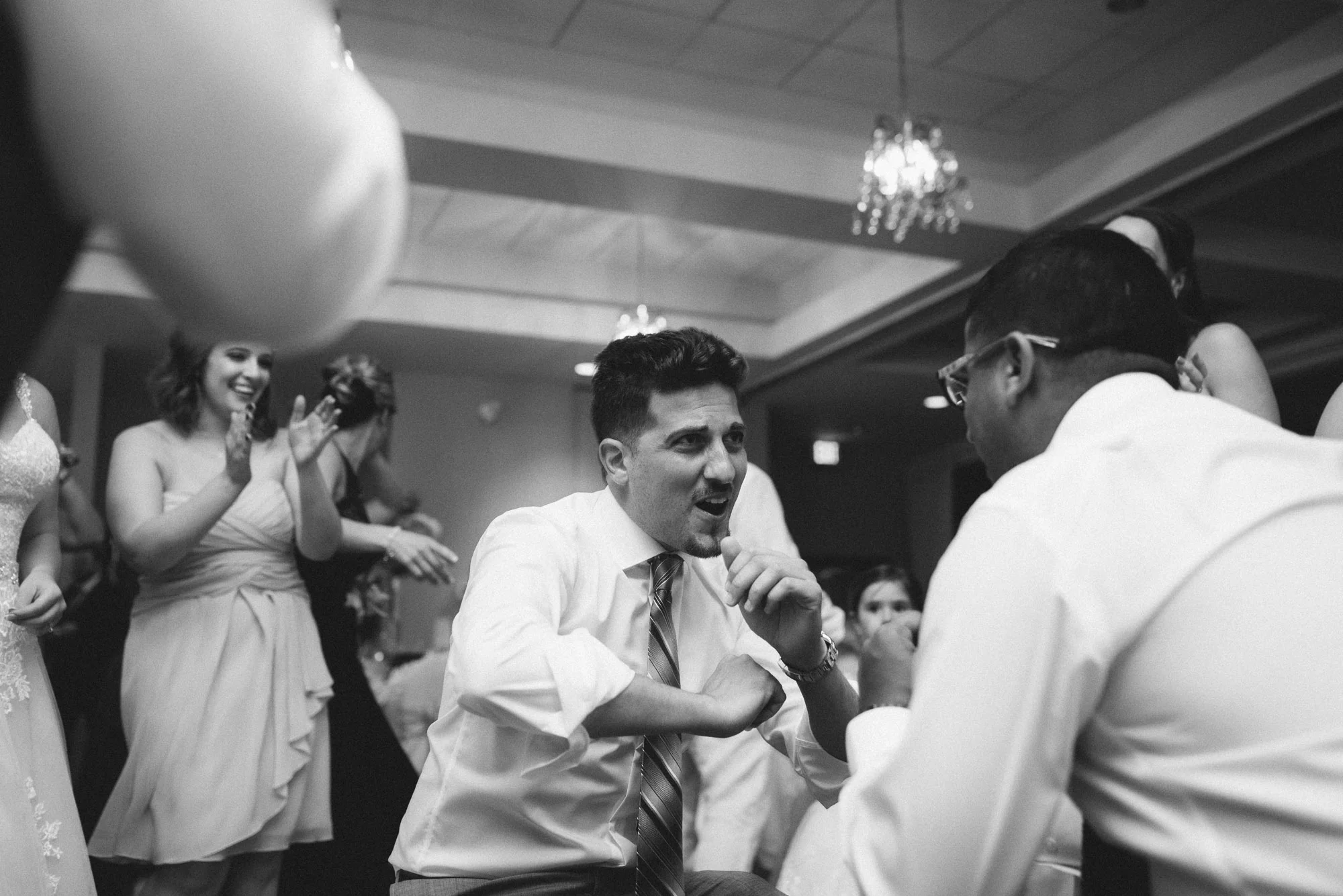 Guest dancing at reception black and white