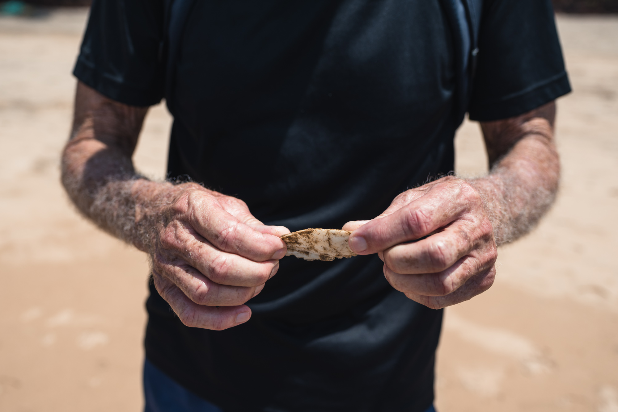 Man with squid at Bogmalo Beach in Goa