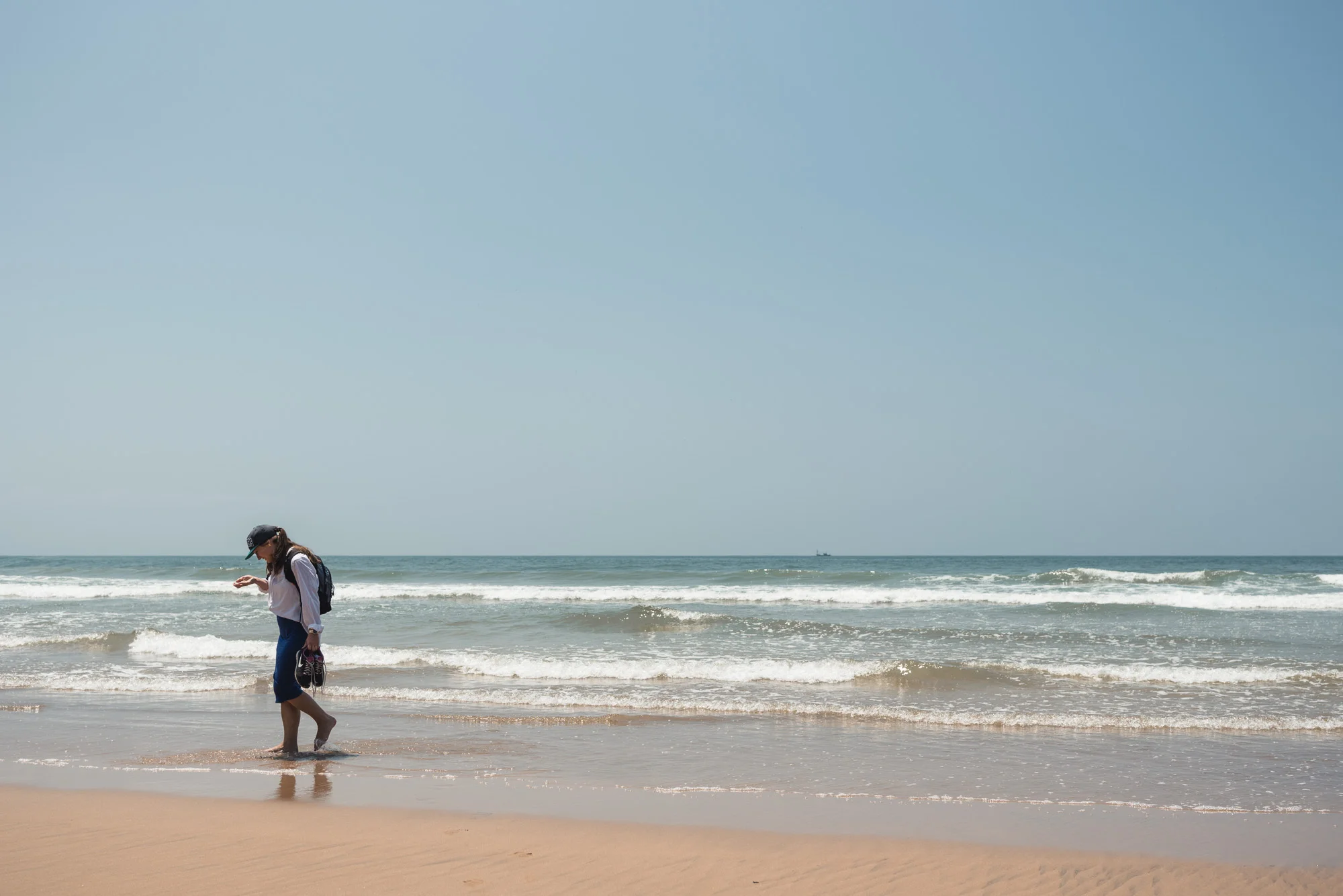 Woman walking at Bogmalo Beach in Goa