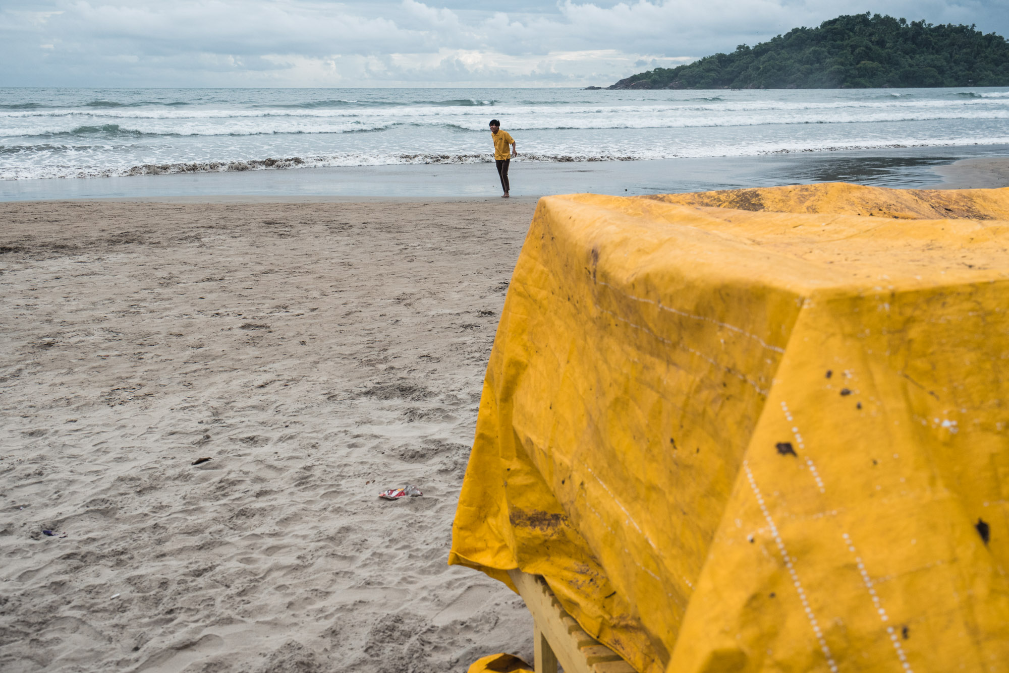 Man standing in yellow at Fishing at Palolem Beach, Goa