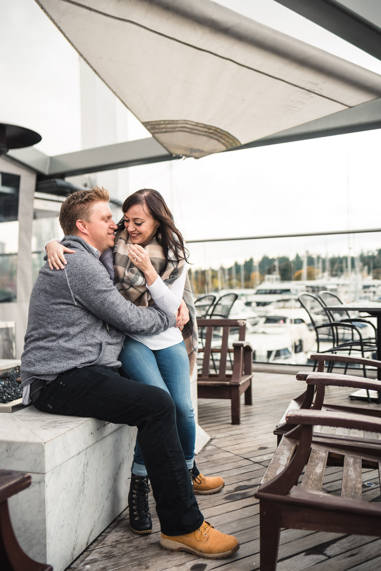 Couple hugs on patio