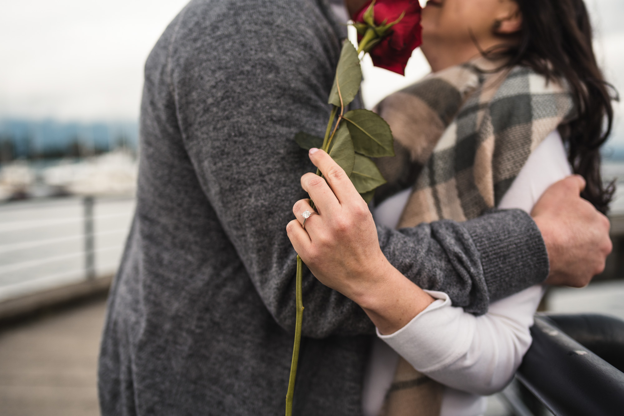 Couple kissing with rose and ring