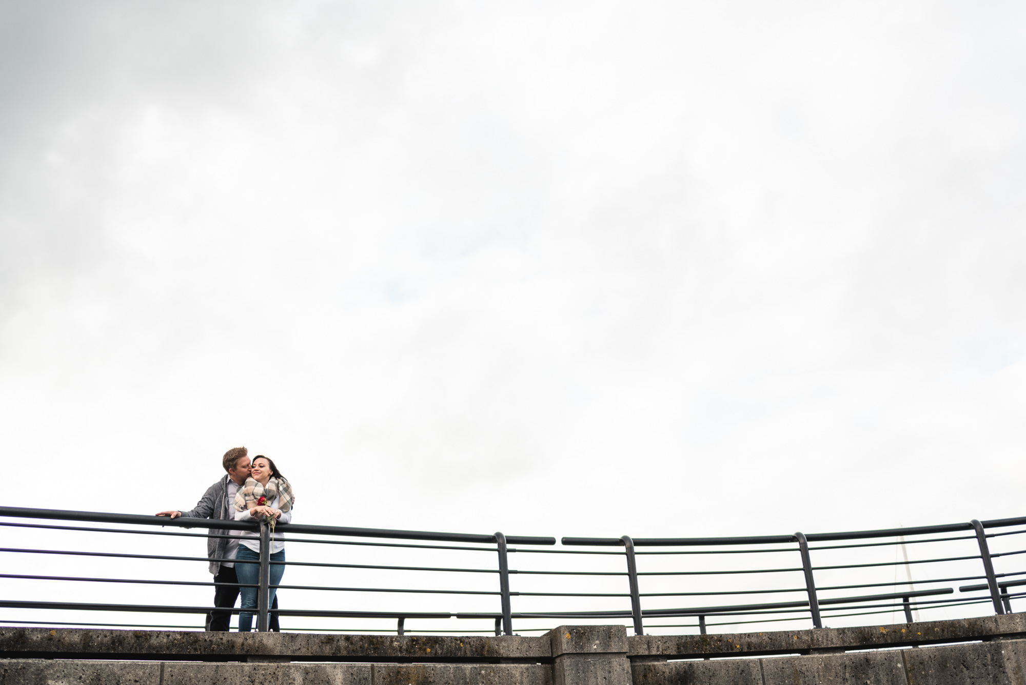 Couple hugging on seawall
