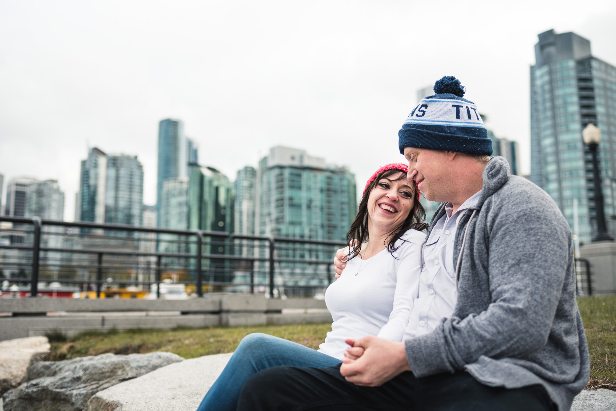 Couple laughs while wearing football toques