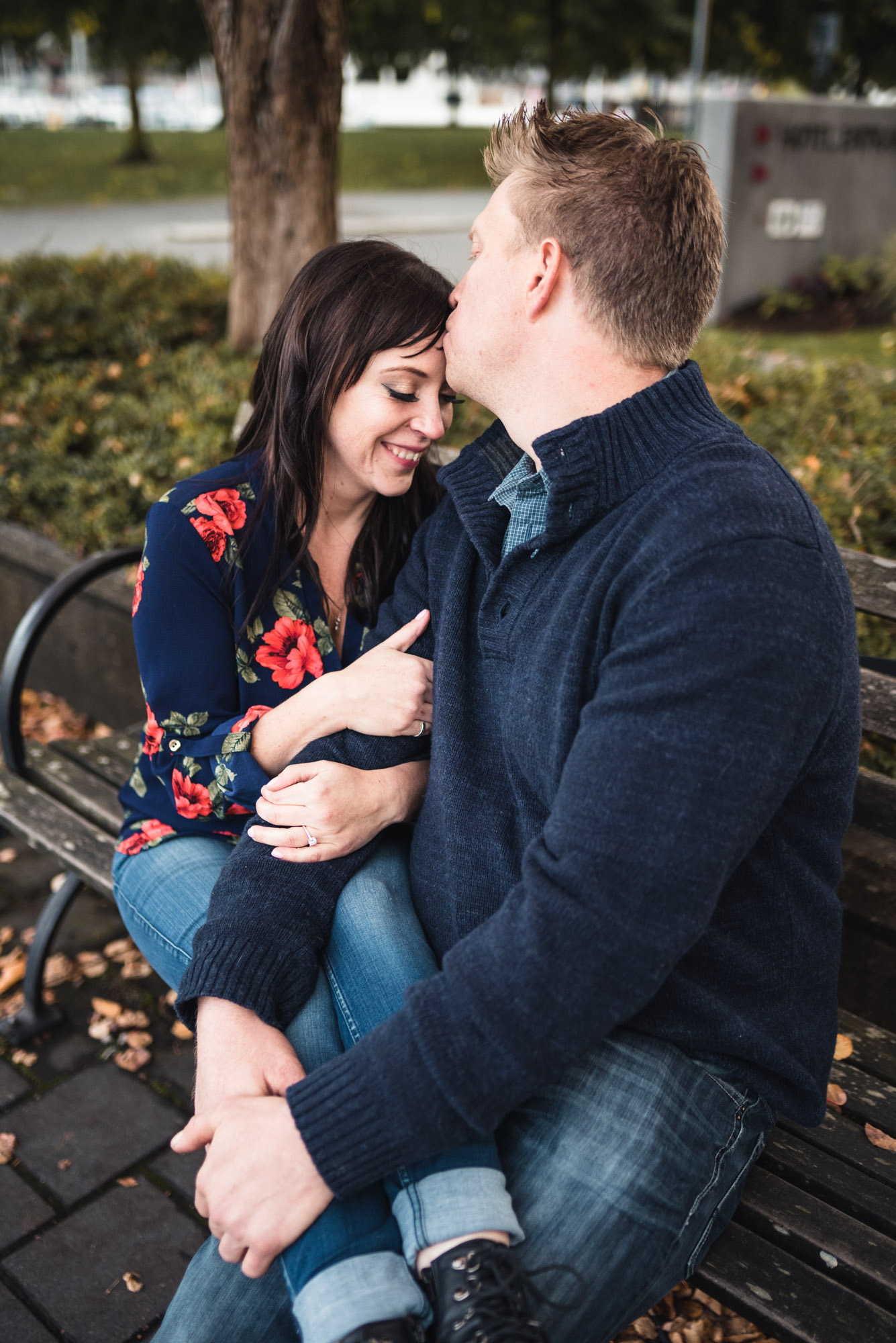 Couple hugs on park bench