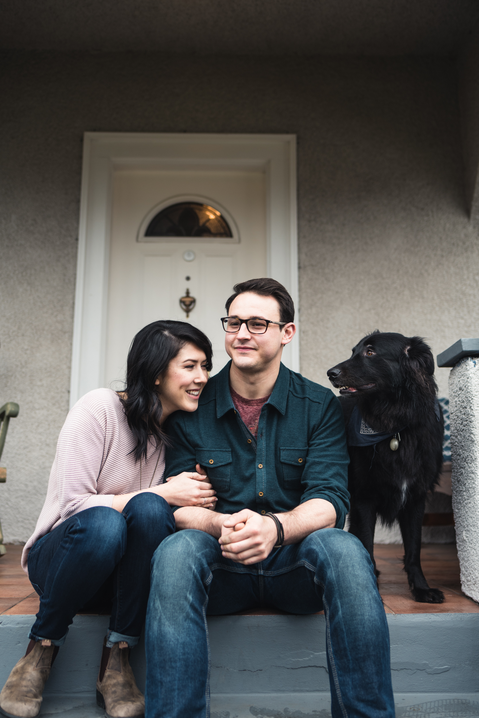 Couple on front steps with dog