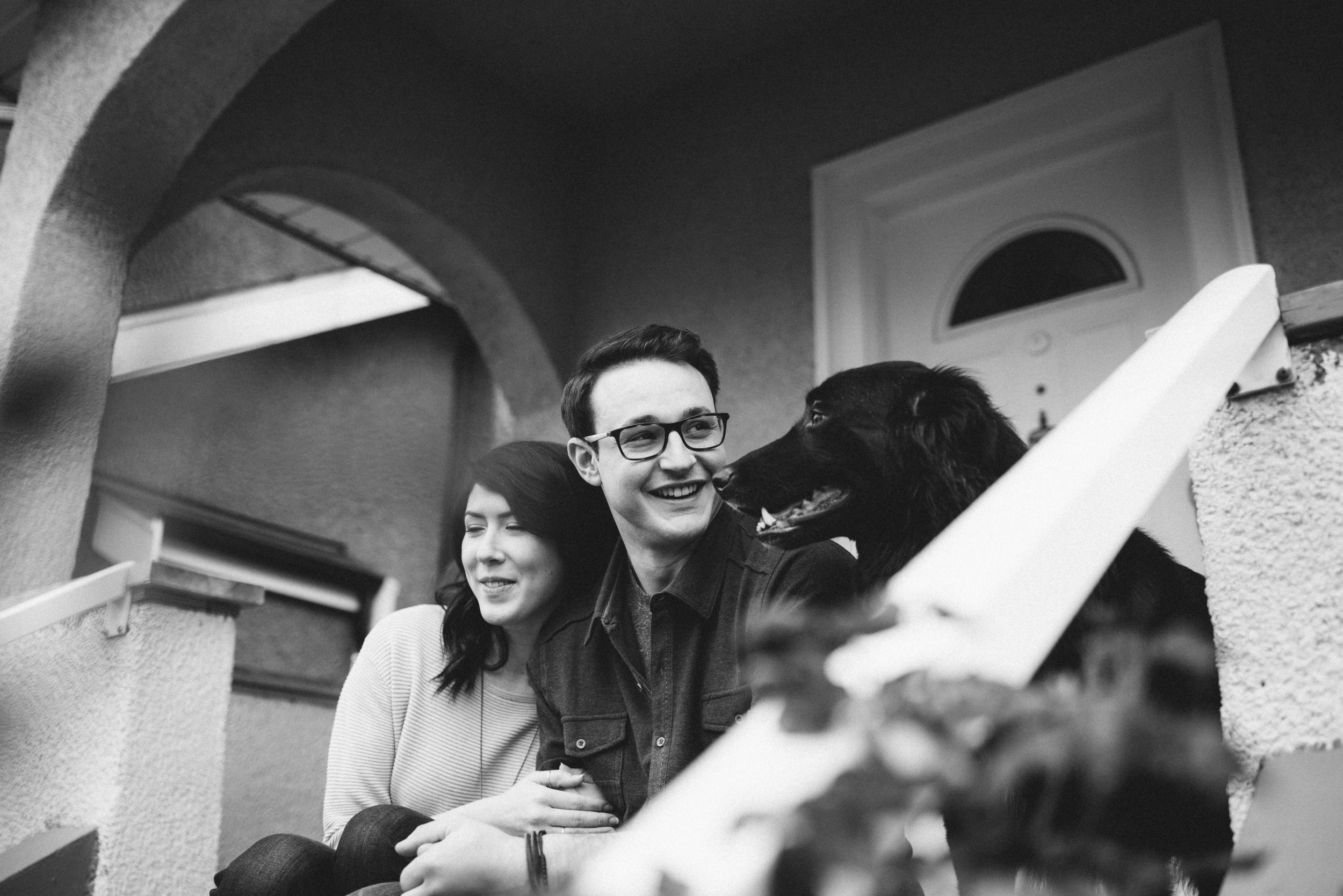 Couple on front steps with dog