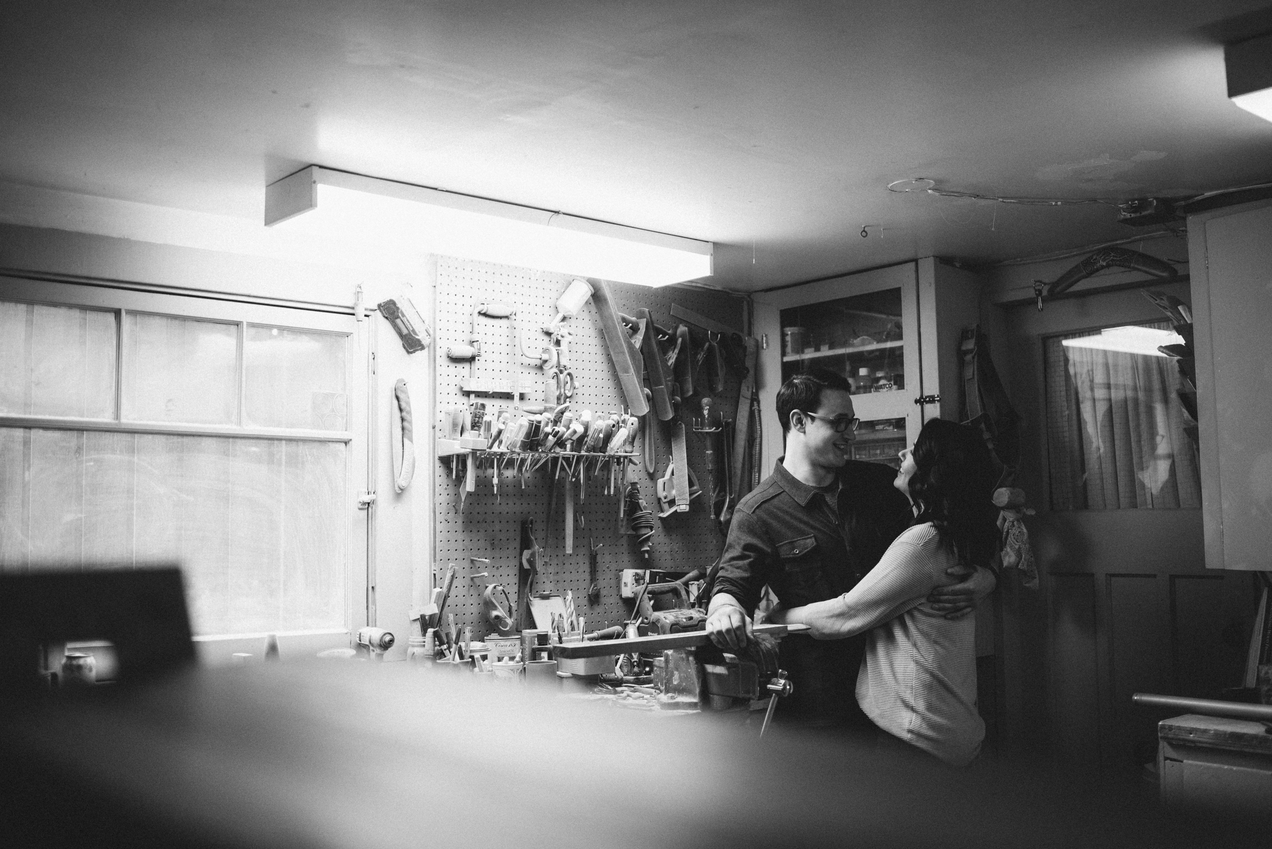 Couple hugging in workshop