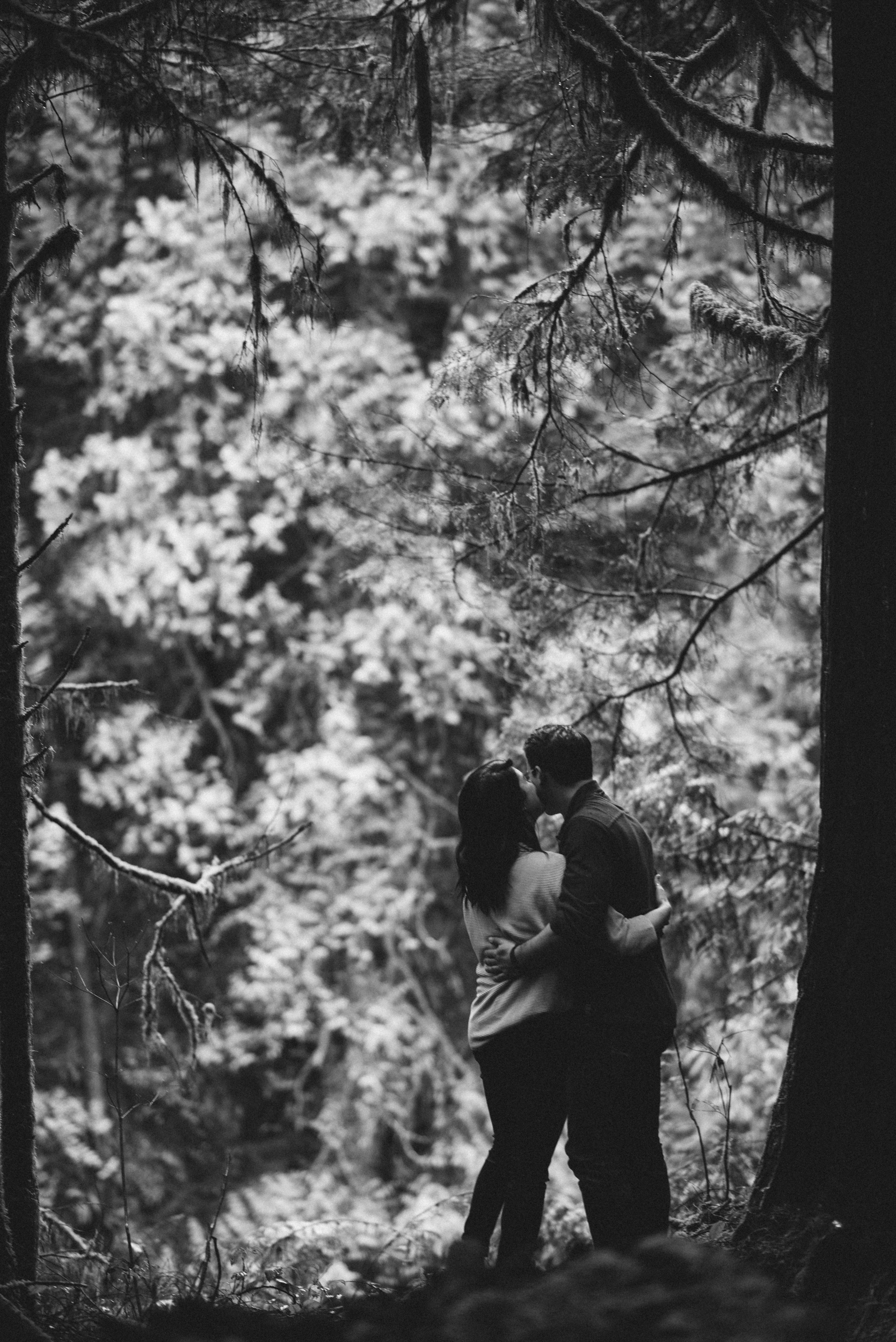 Couple embracing in forest black and white