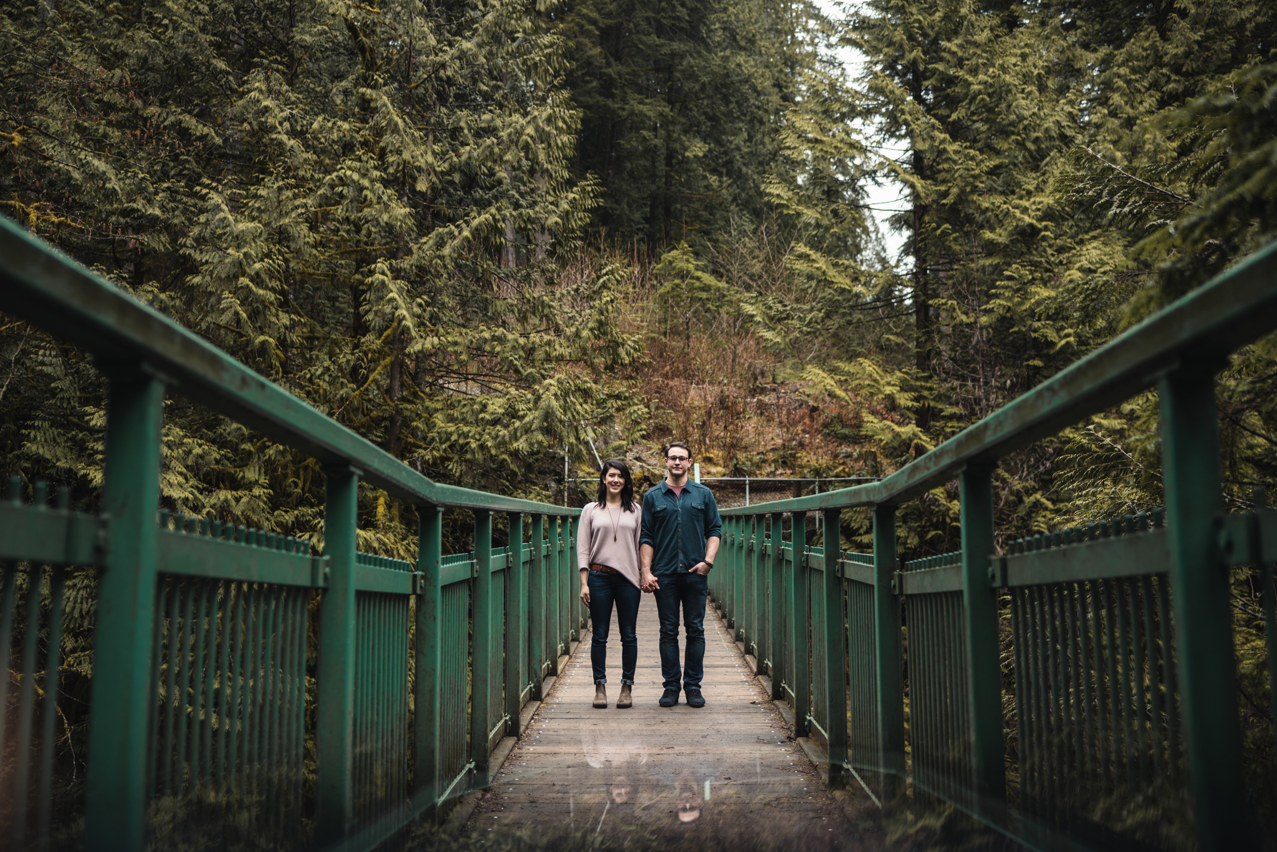 Couple holding hands on bridge