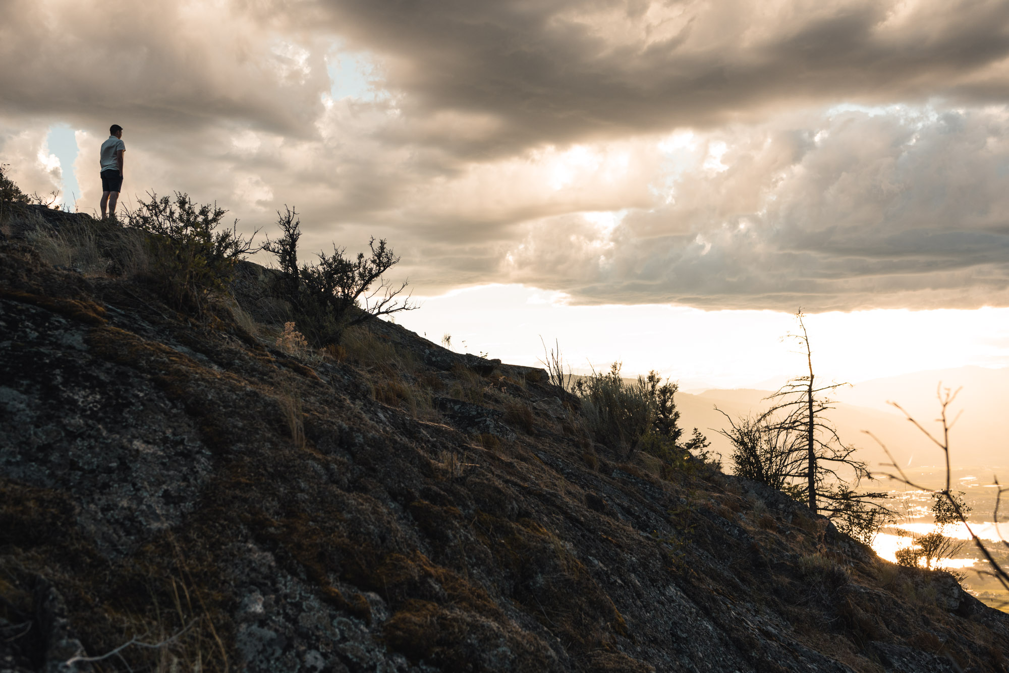 Man stands with sunset on Anarchist Mountain, Osoyoos