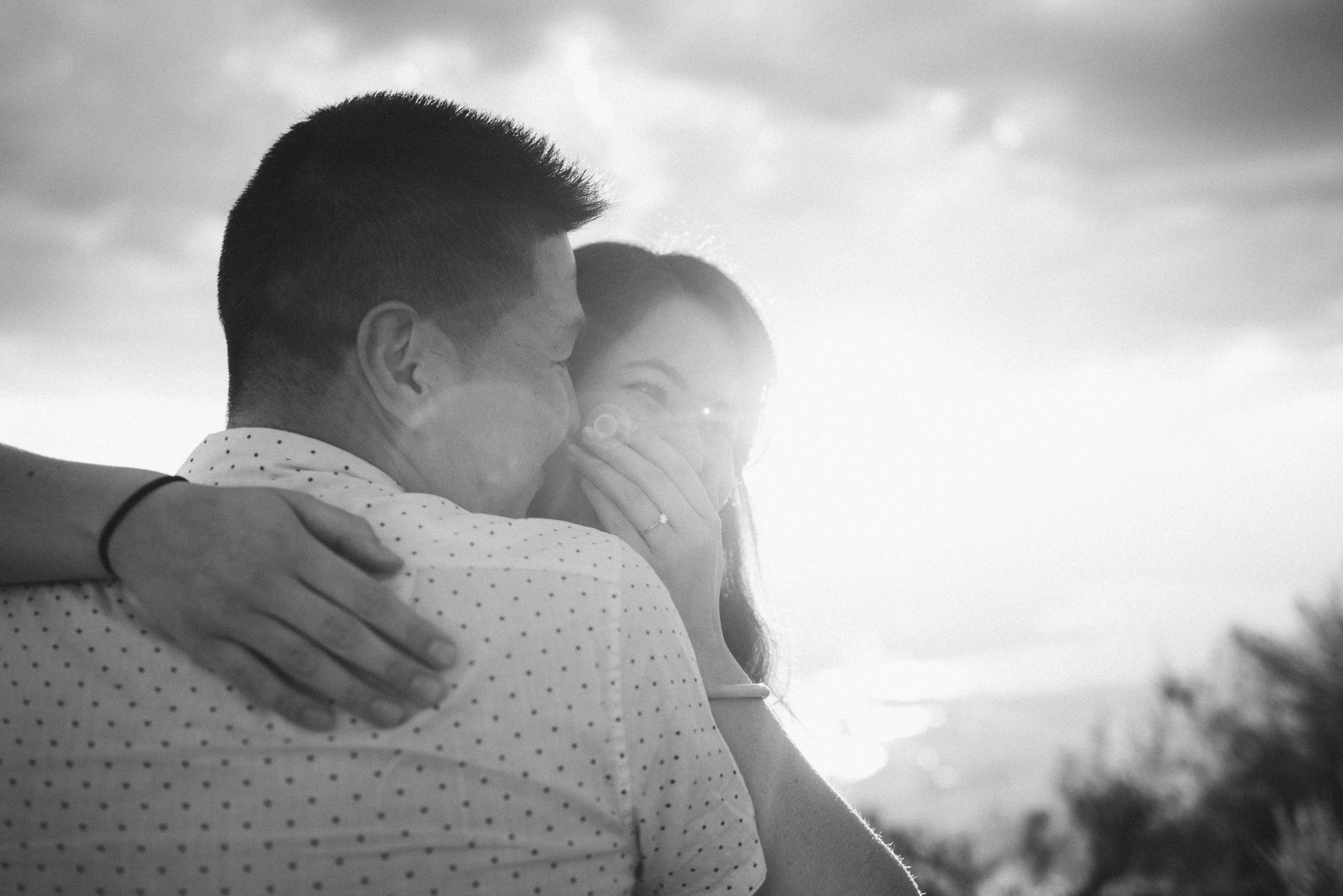 Engaged couple embraces with sunset on Anarchist Mountain, Osoyoos