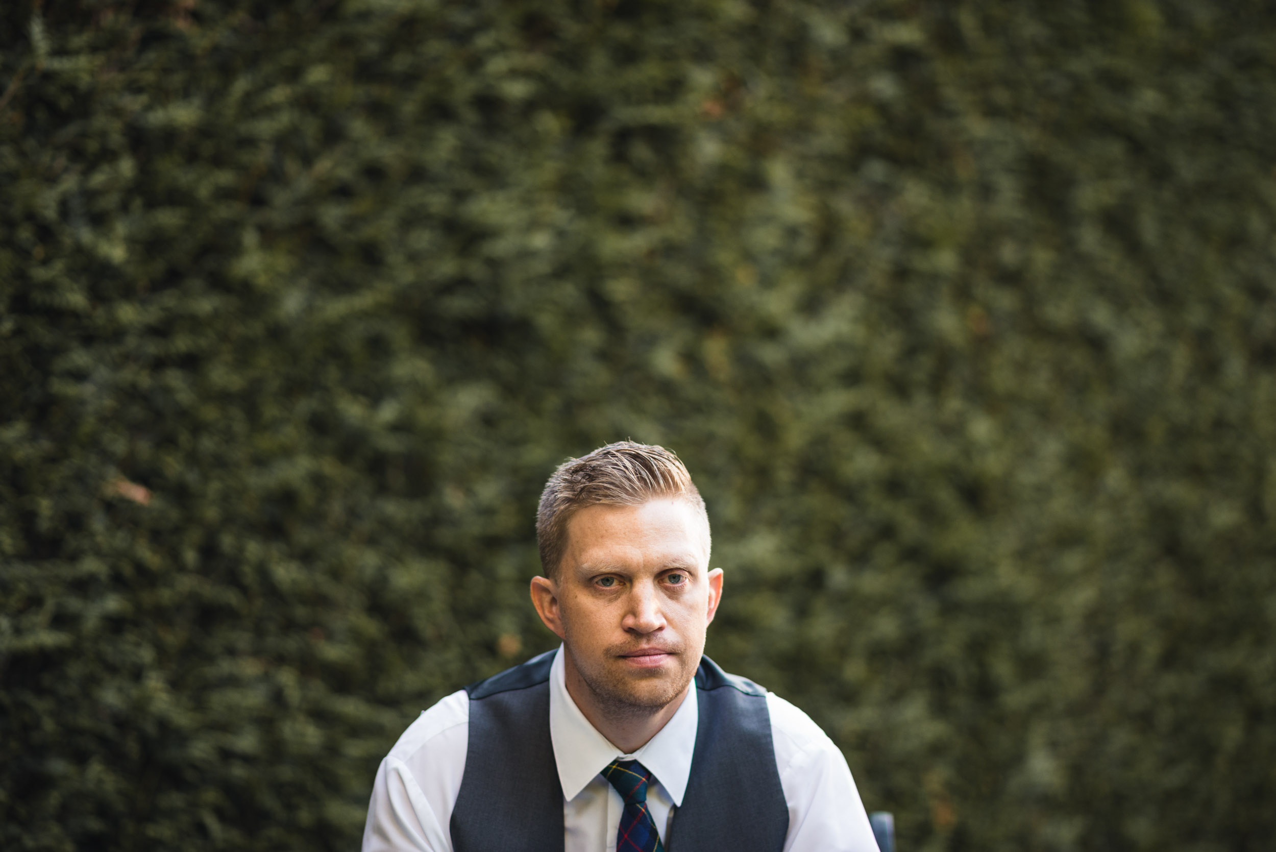 Groom sitting in garden