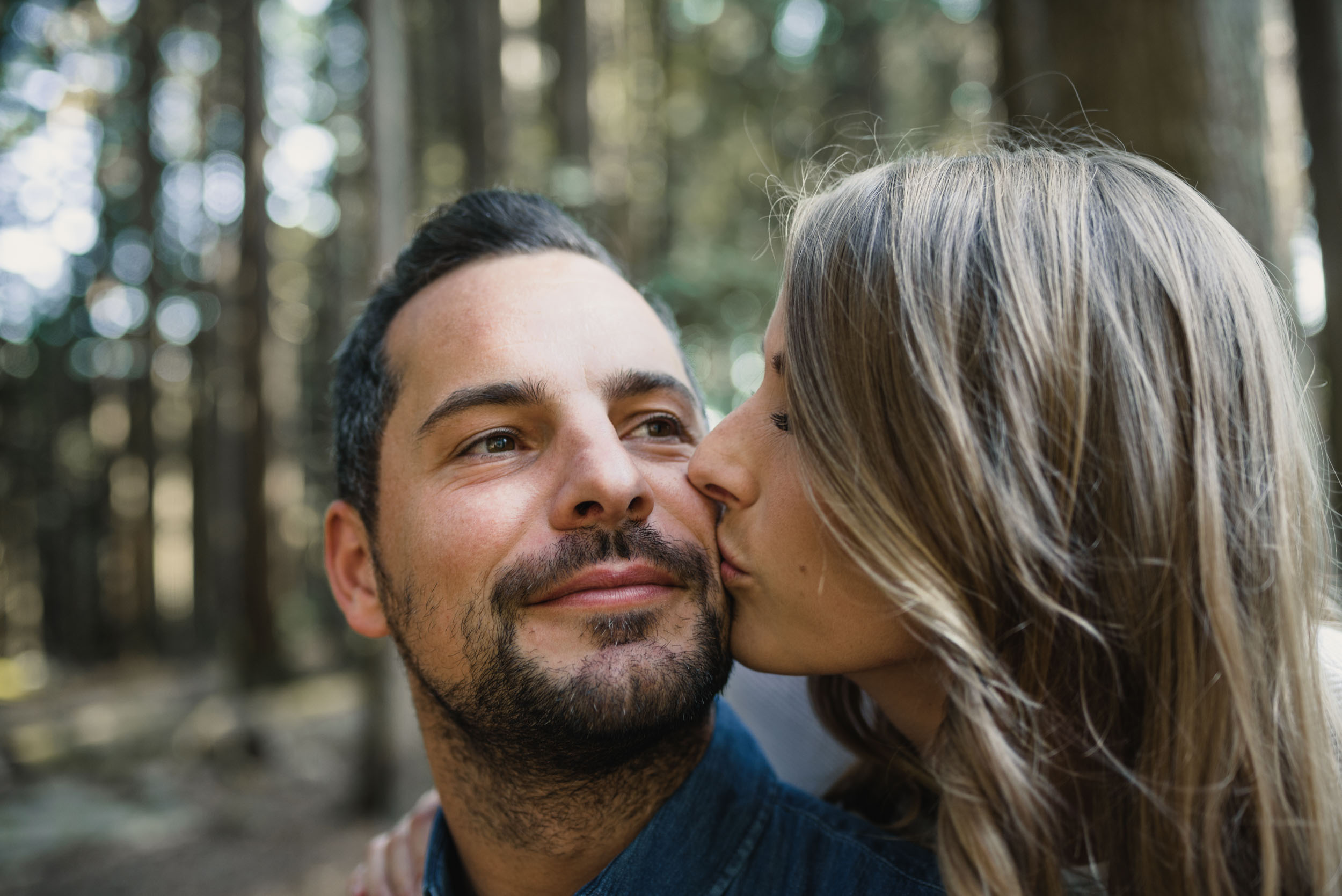 Couple kisses in the forest