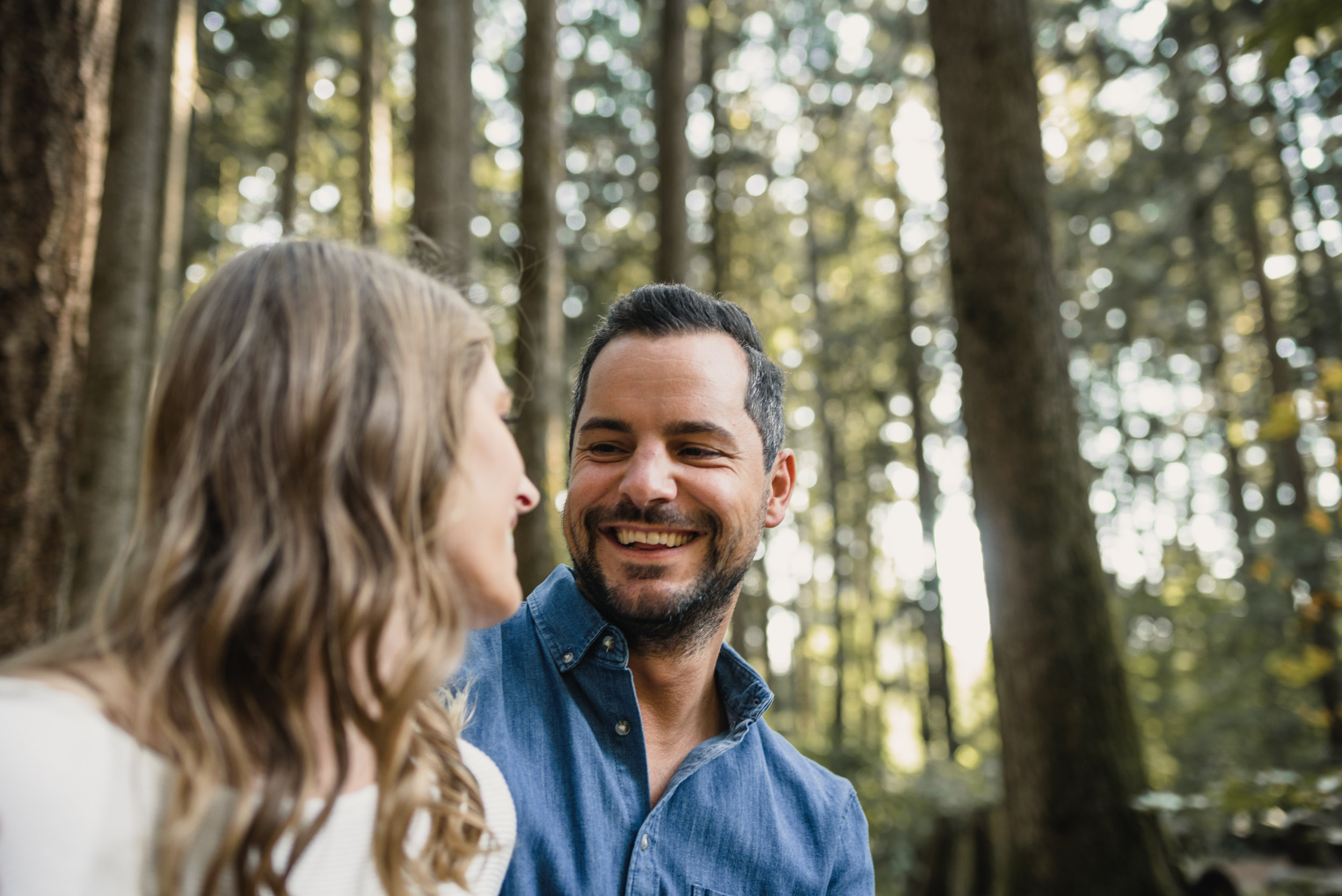 Couple hanging out in forest looking at each other