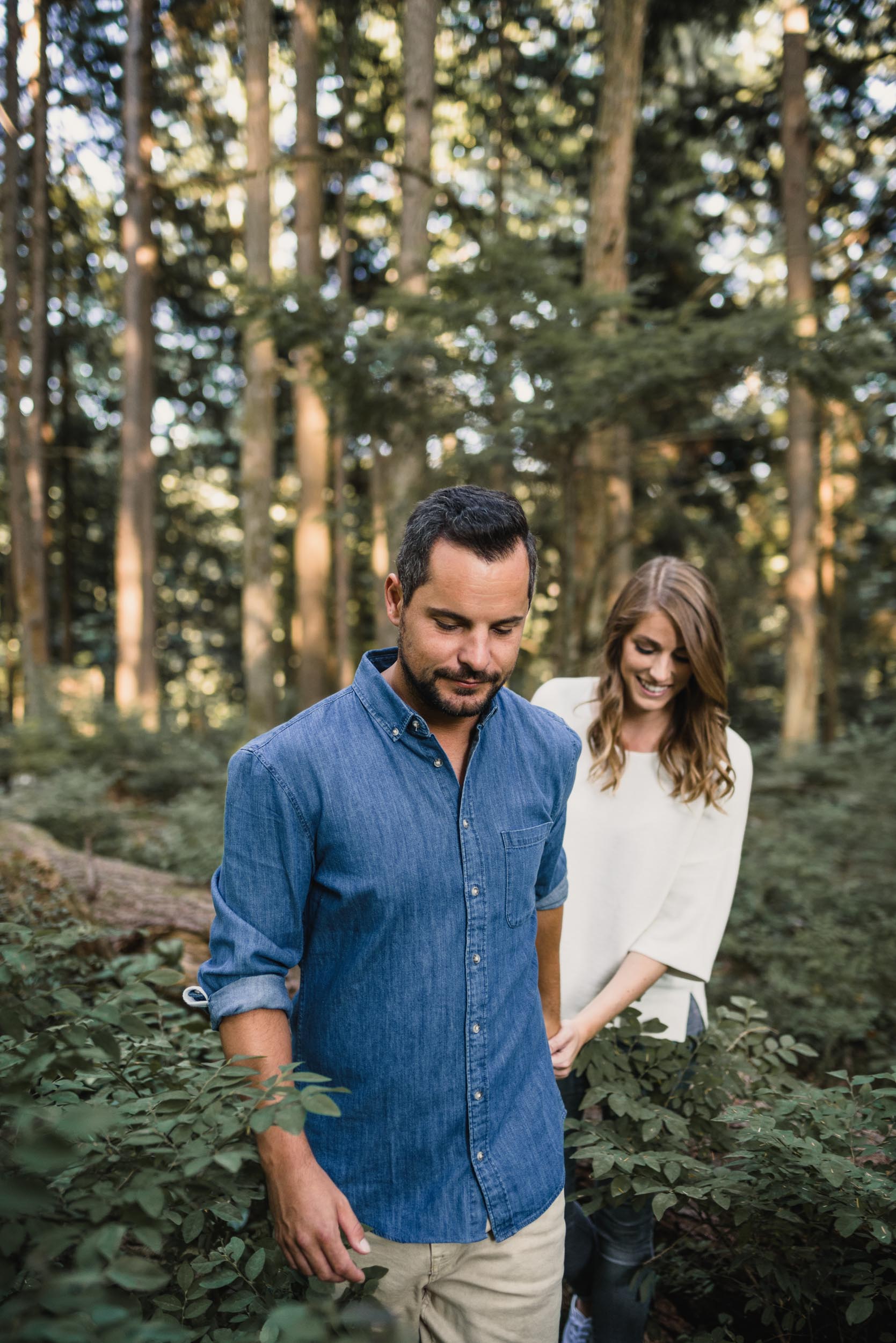 Couple walks through forest together