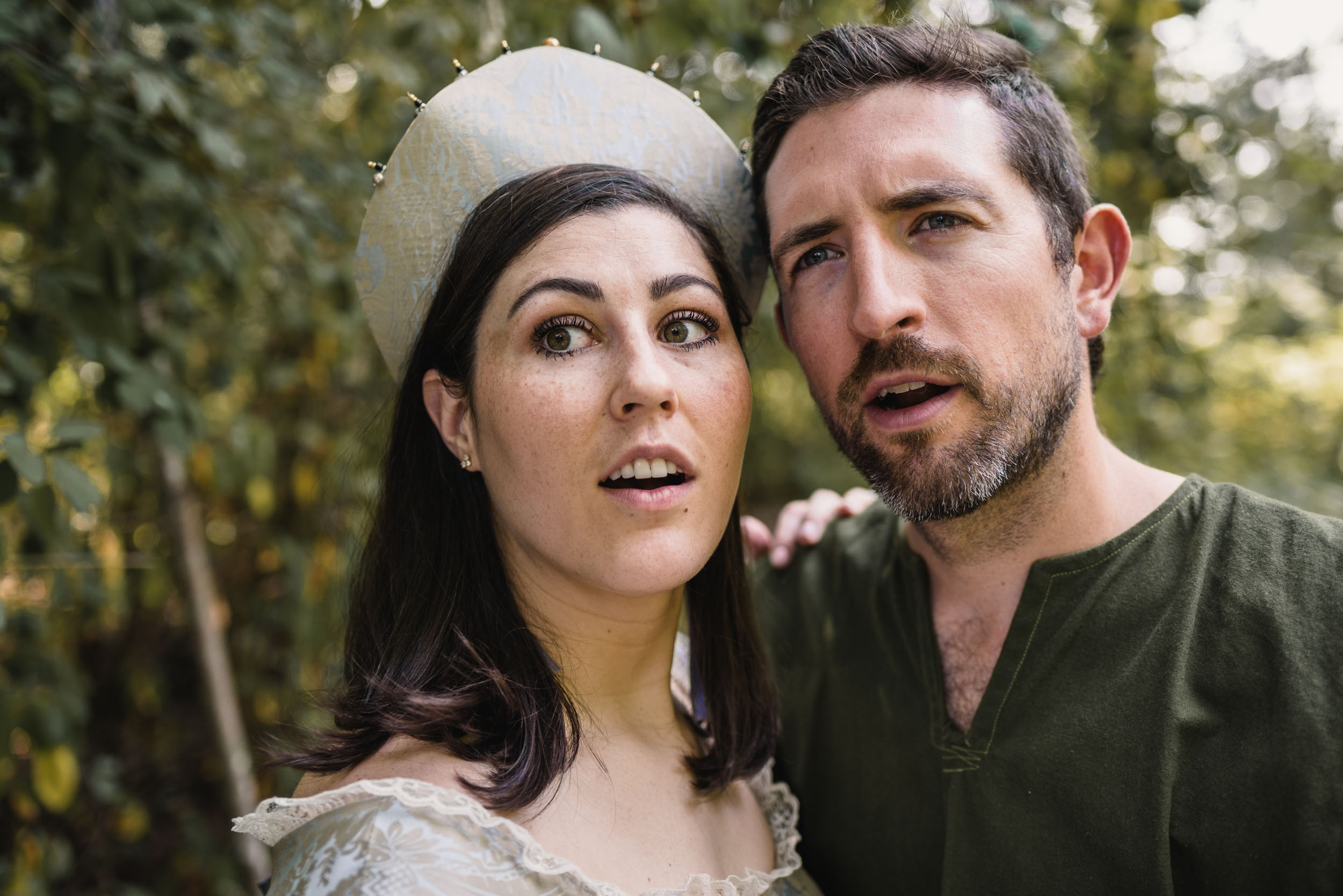 Shocked looking couple with medieval costumes