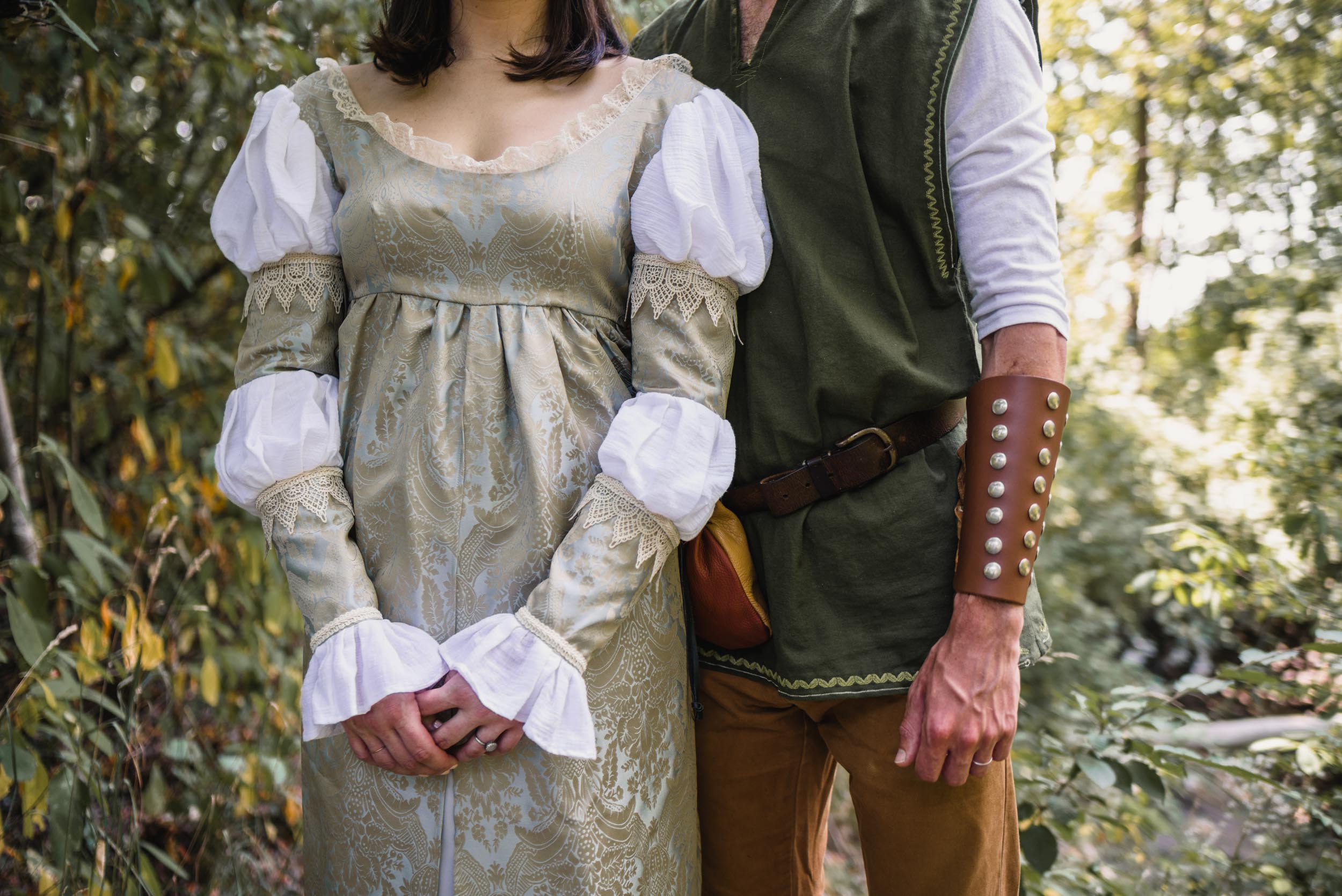 Couple standing with medieval costumes detail