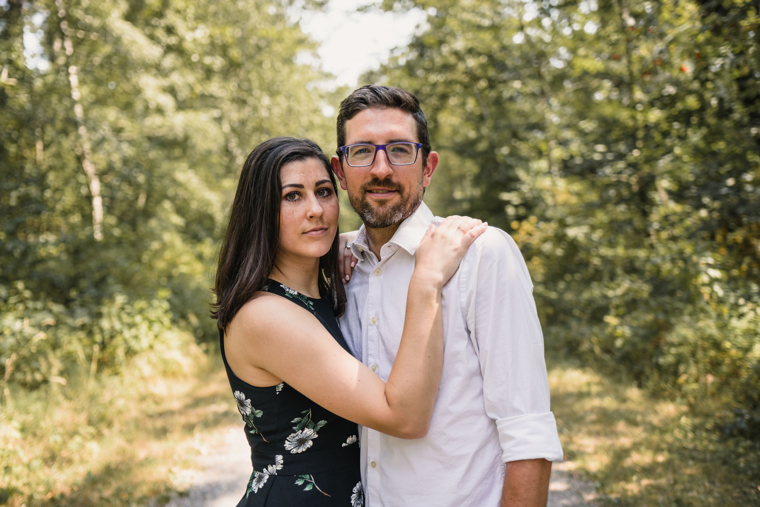 Couple stands together on trail