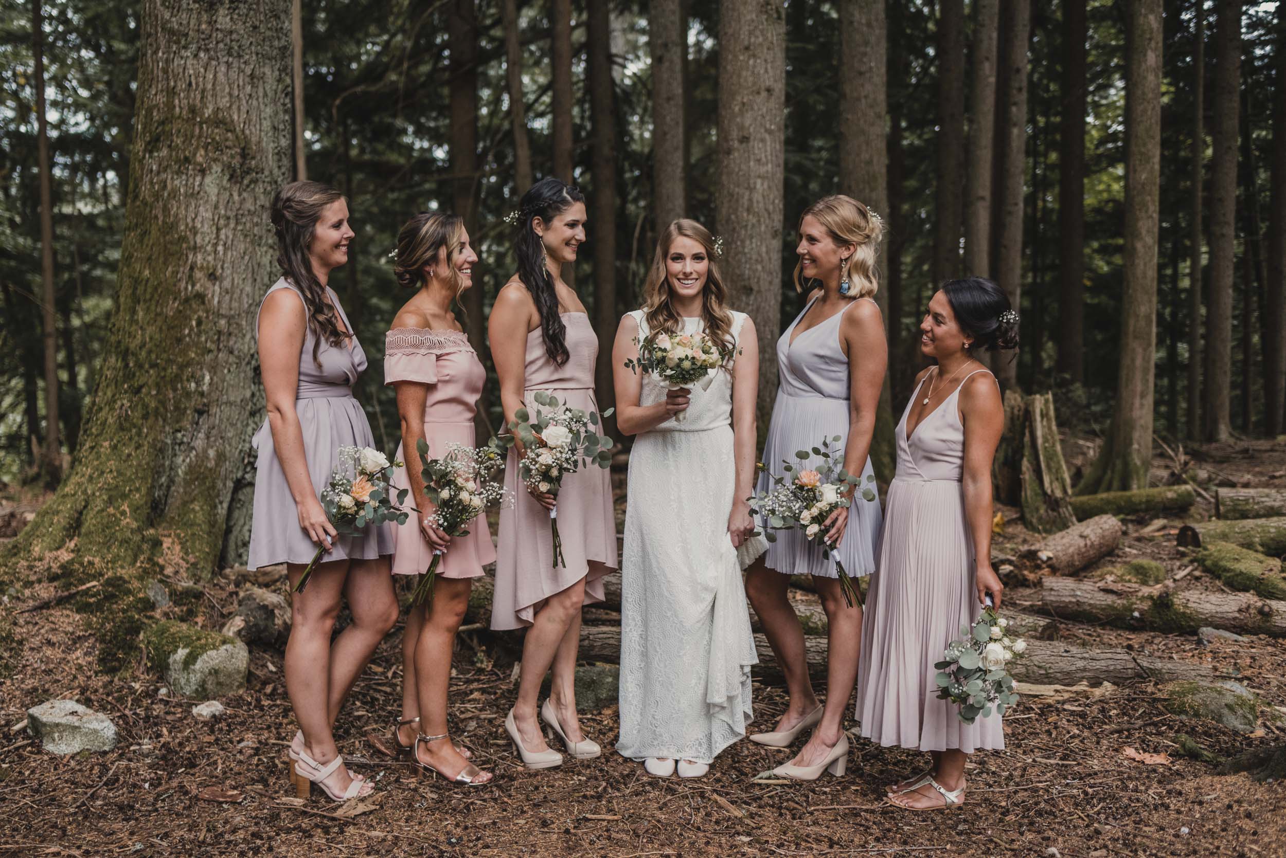 Bride and bridesmaids group photo in forest