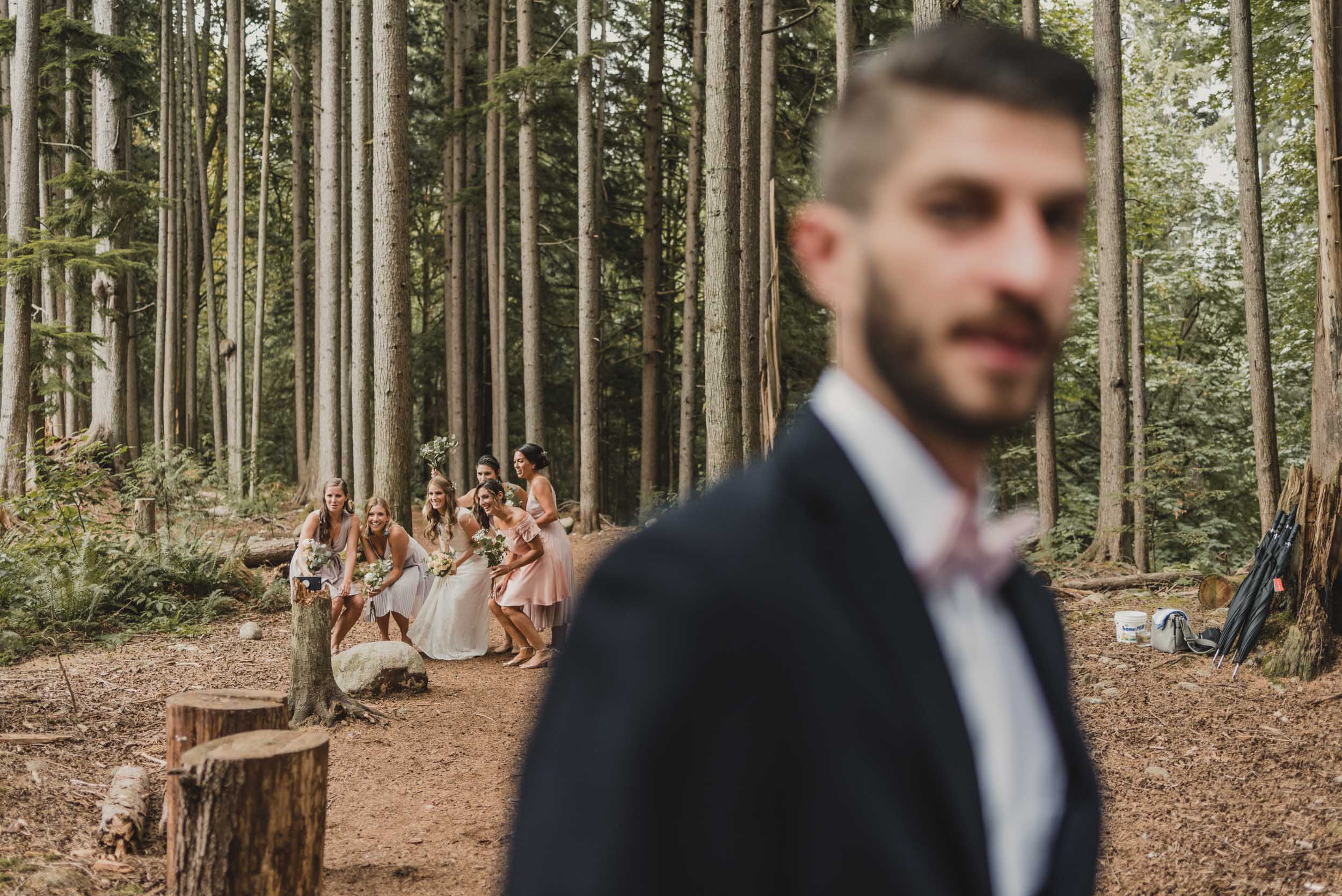 Bride and bridesmaids take photo in background