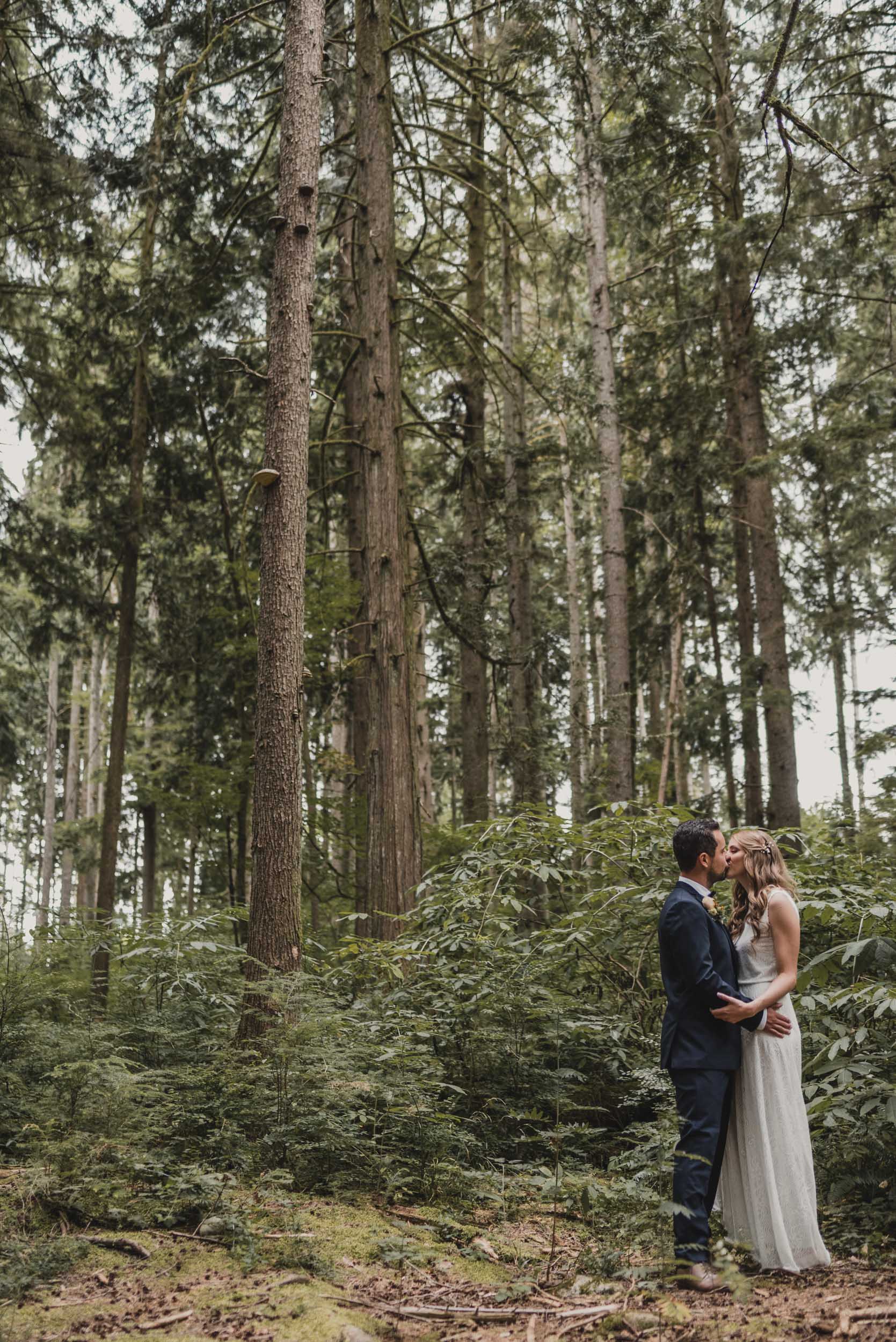 Bride and Groom embrace in forest