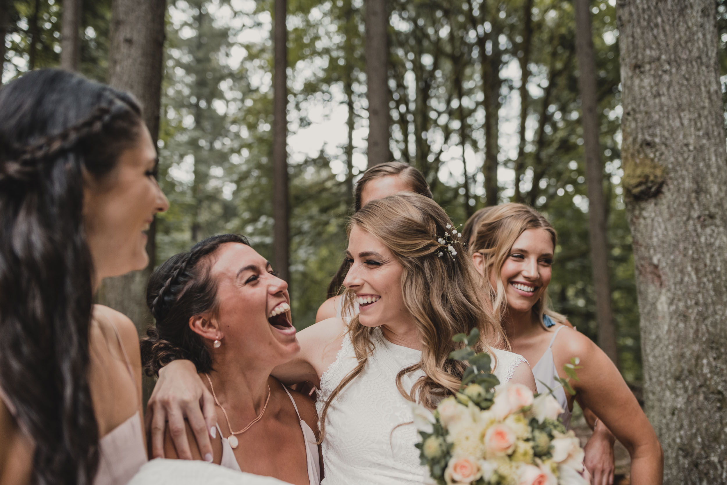 Bride laughing with bridesmaids