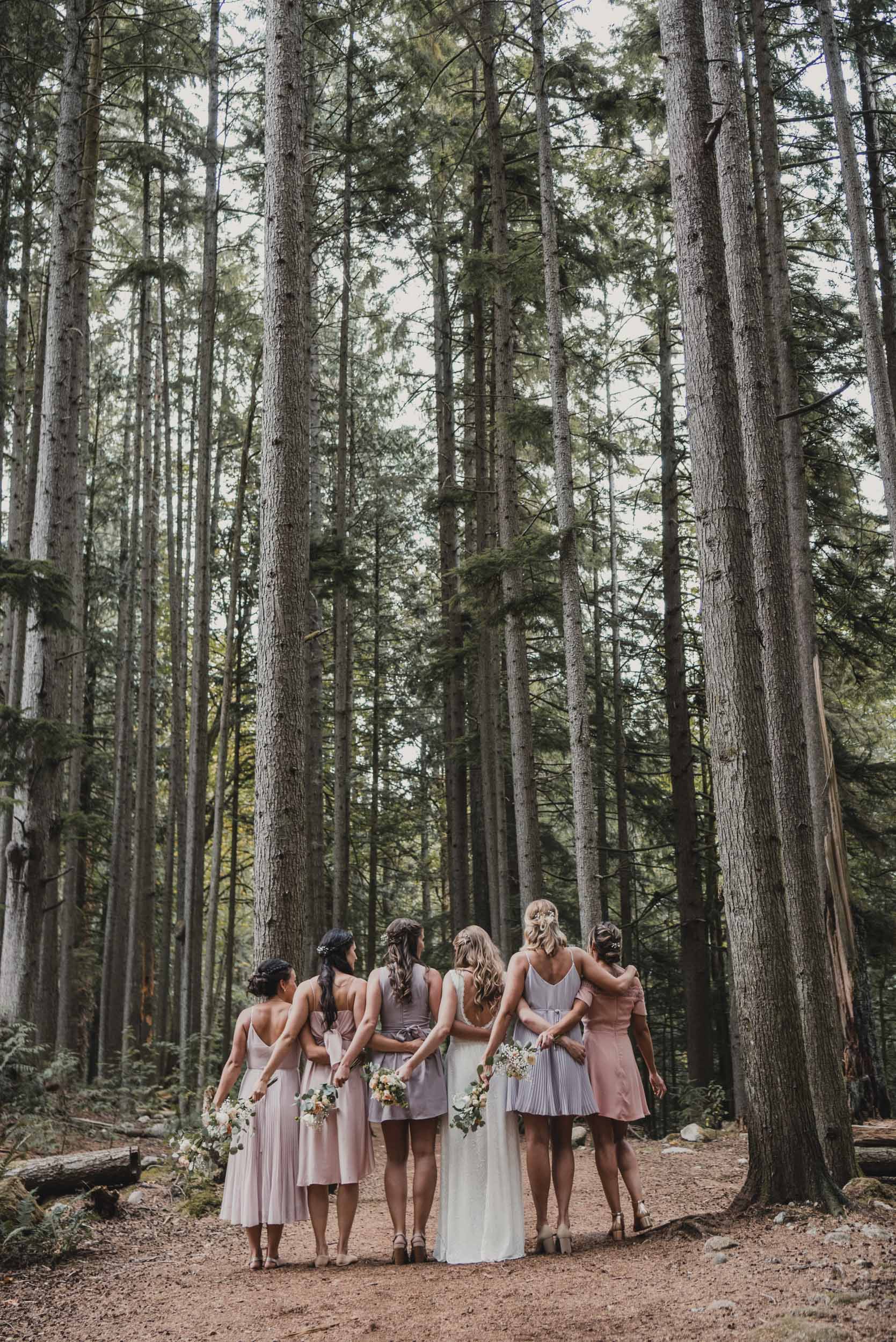 Bride and bridesmaids in forest