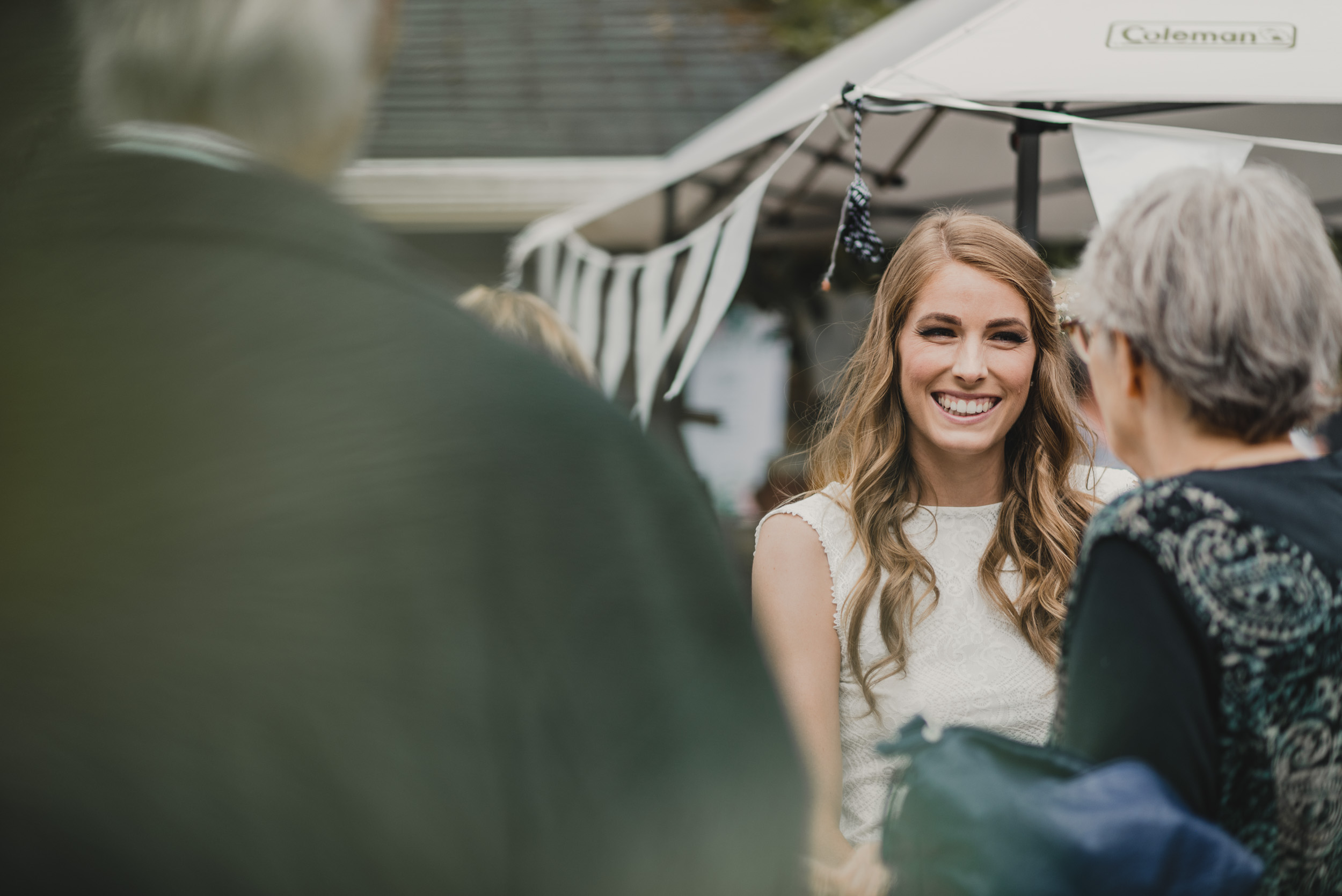 Bride smiling with guests at reception