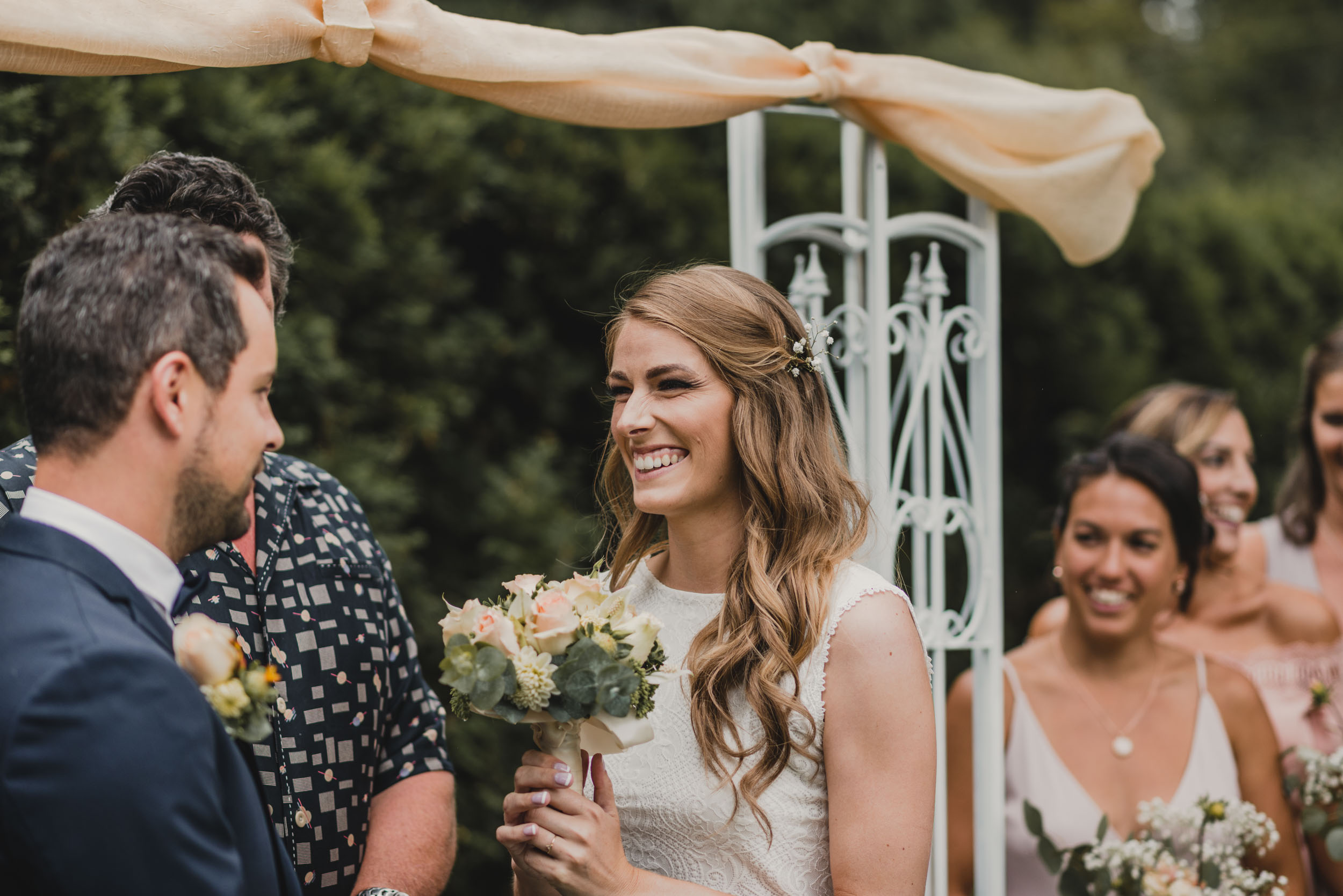 Bride smiling at groom at altar