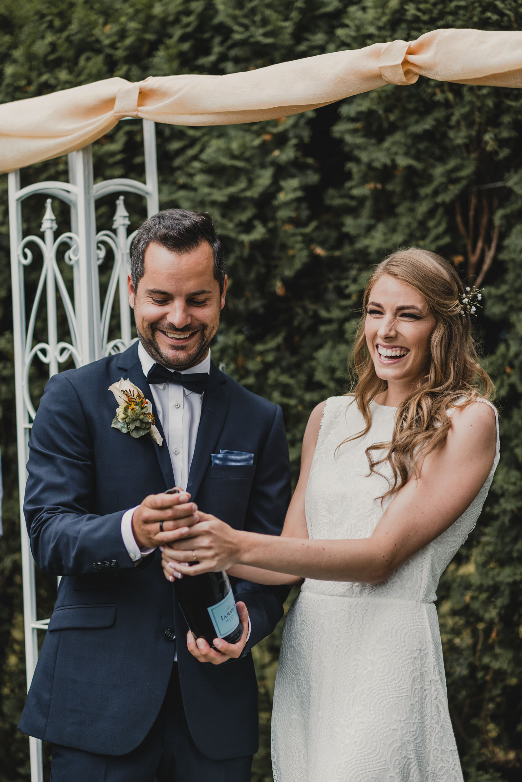 Bride and Groom open champagne