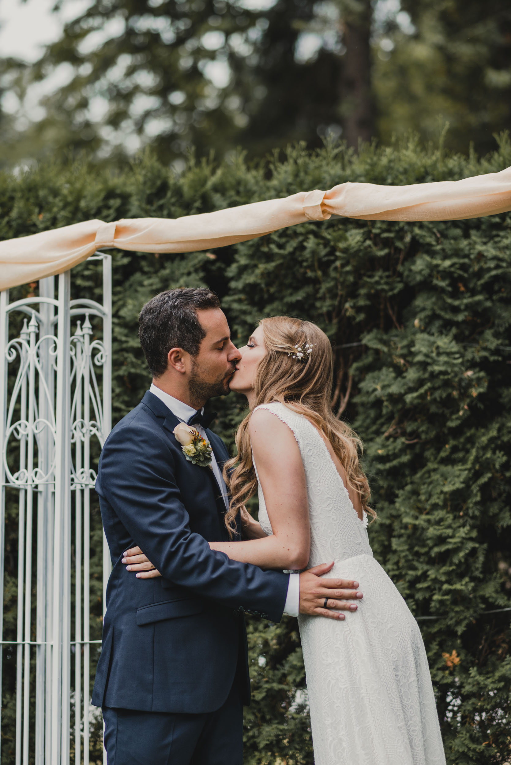 Bride and Groom kissing at altar