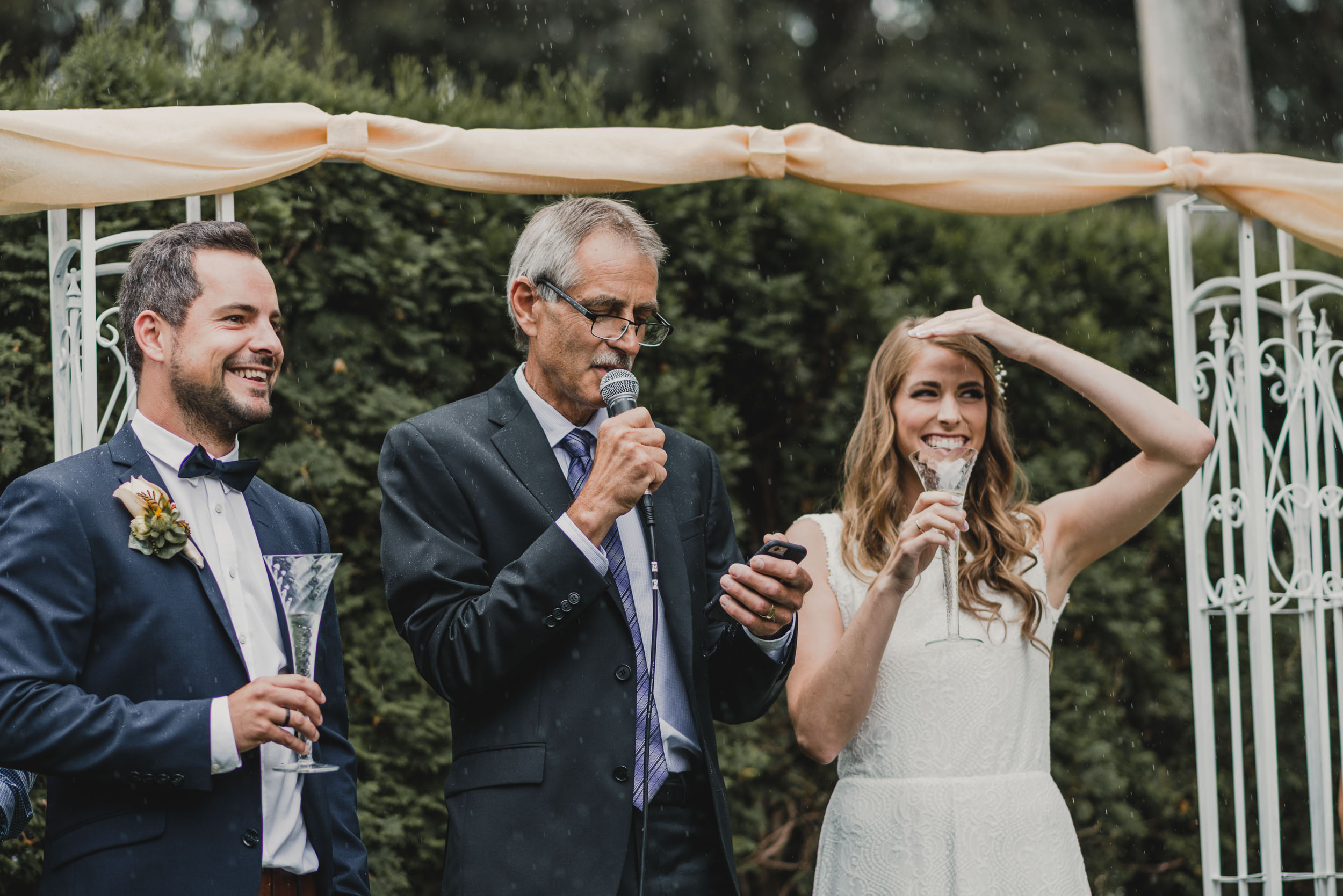 Father of the Bride recites speech during rain