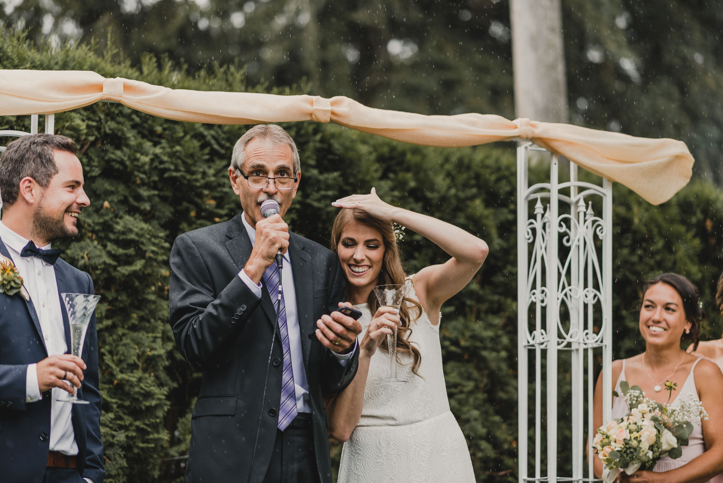 Father of the Bride recites speech during rain