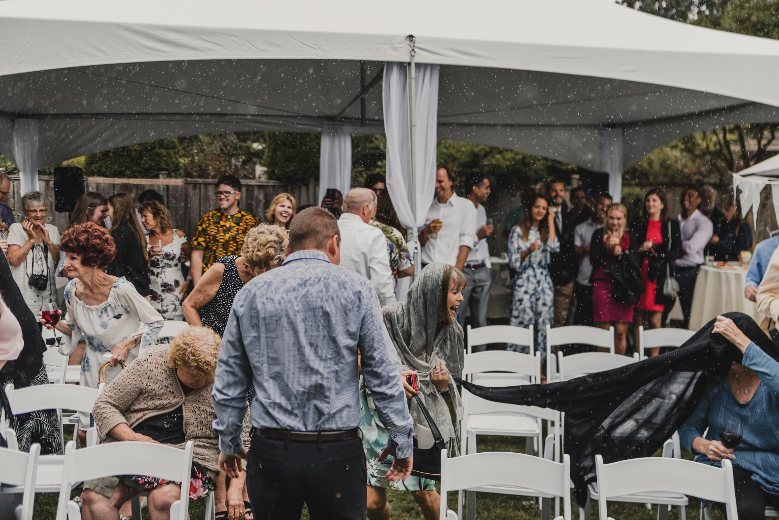 Wedding guests running from rain