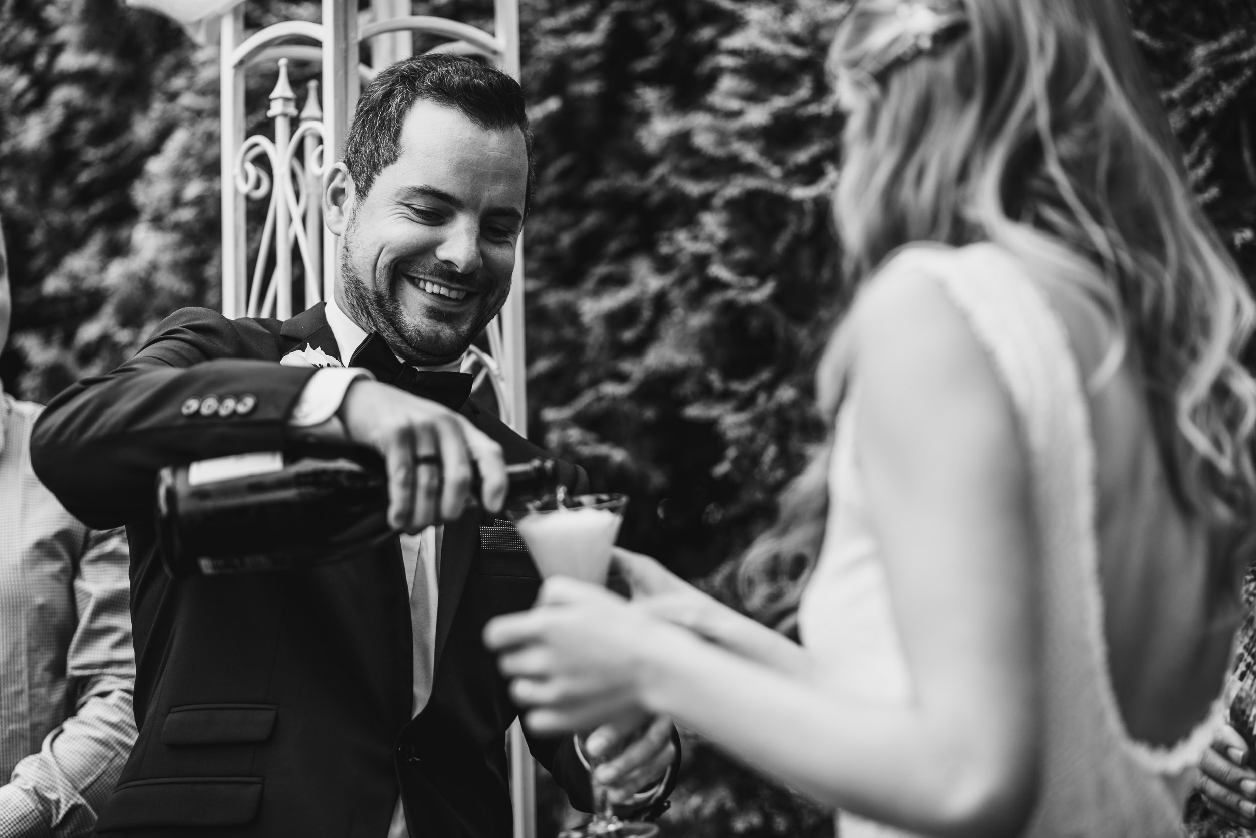 Groom pours champagne